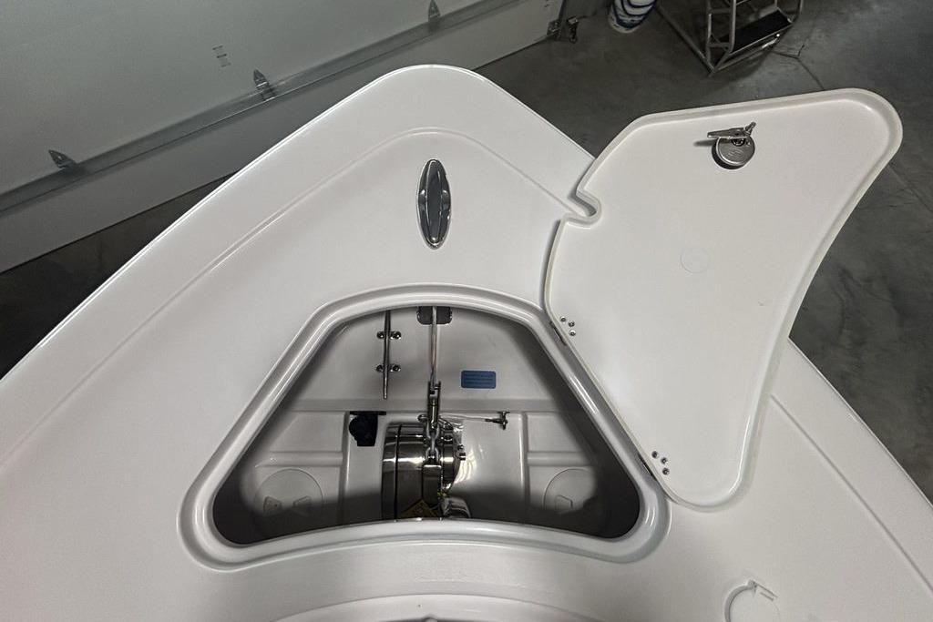 Open anchor compartment of 2026 Sportsman Open 252 Center Console boat in a garage.