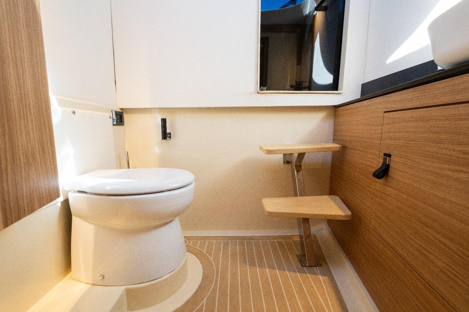 Modern bathroom interior of AlCustom LIPARI 31 yacht, 2025 model, featuring wooden accents.