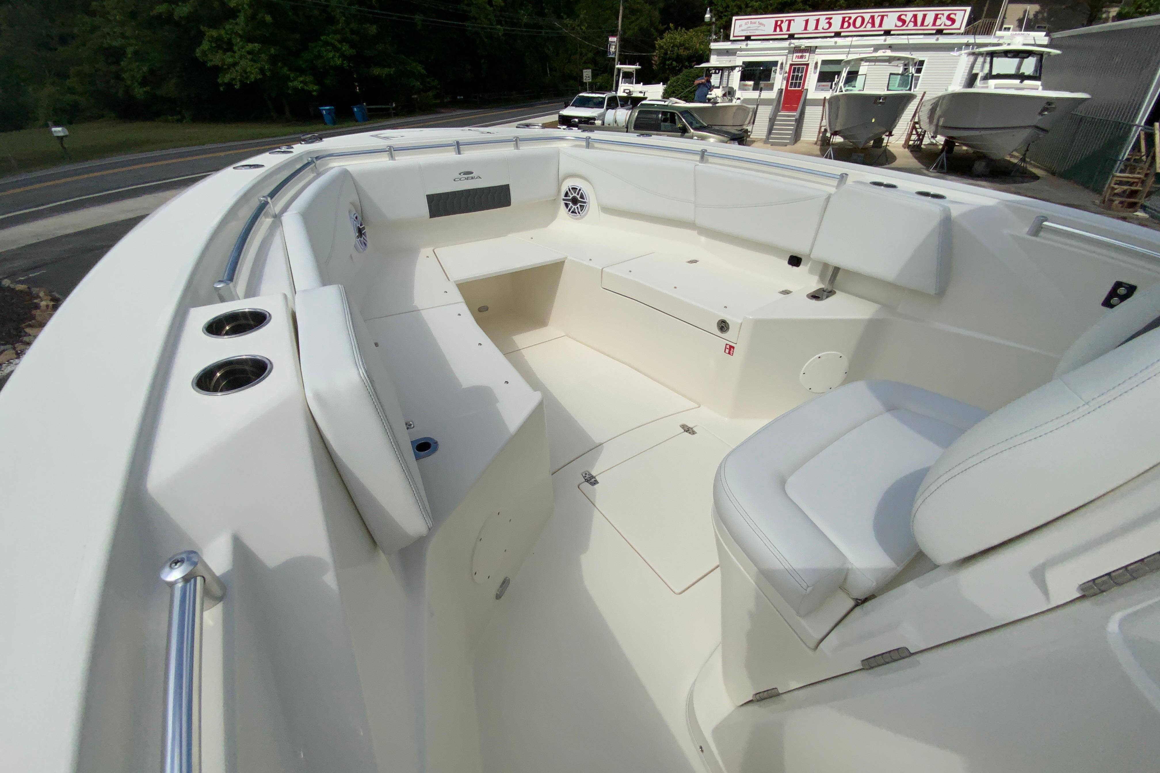 2027 Cobia 320 Center Console boat interior with white seating and cup holders.