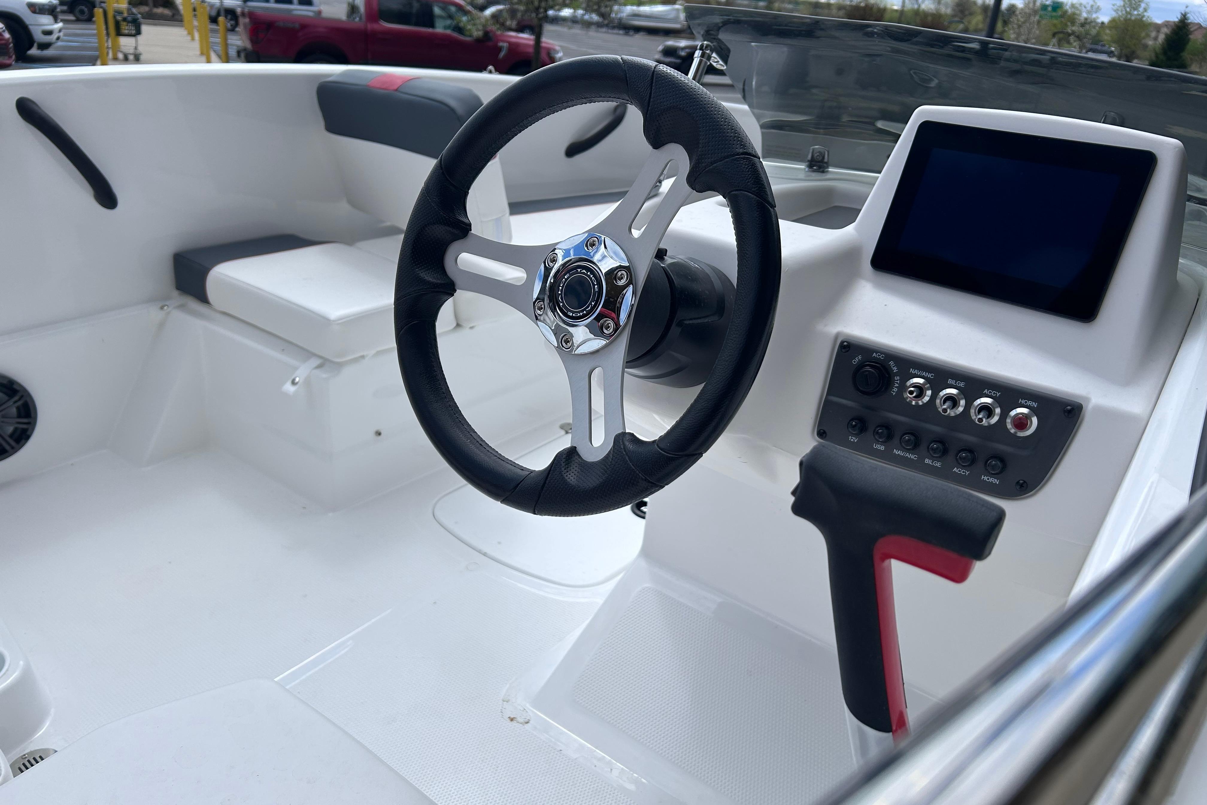 Steering console of 2026 Tahoe T16 boat with modern controls and seating.