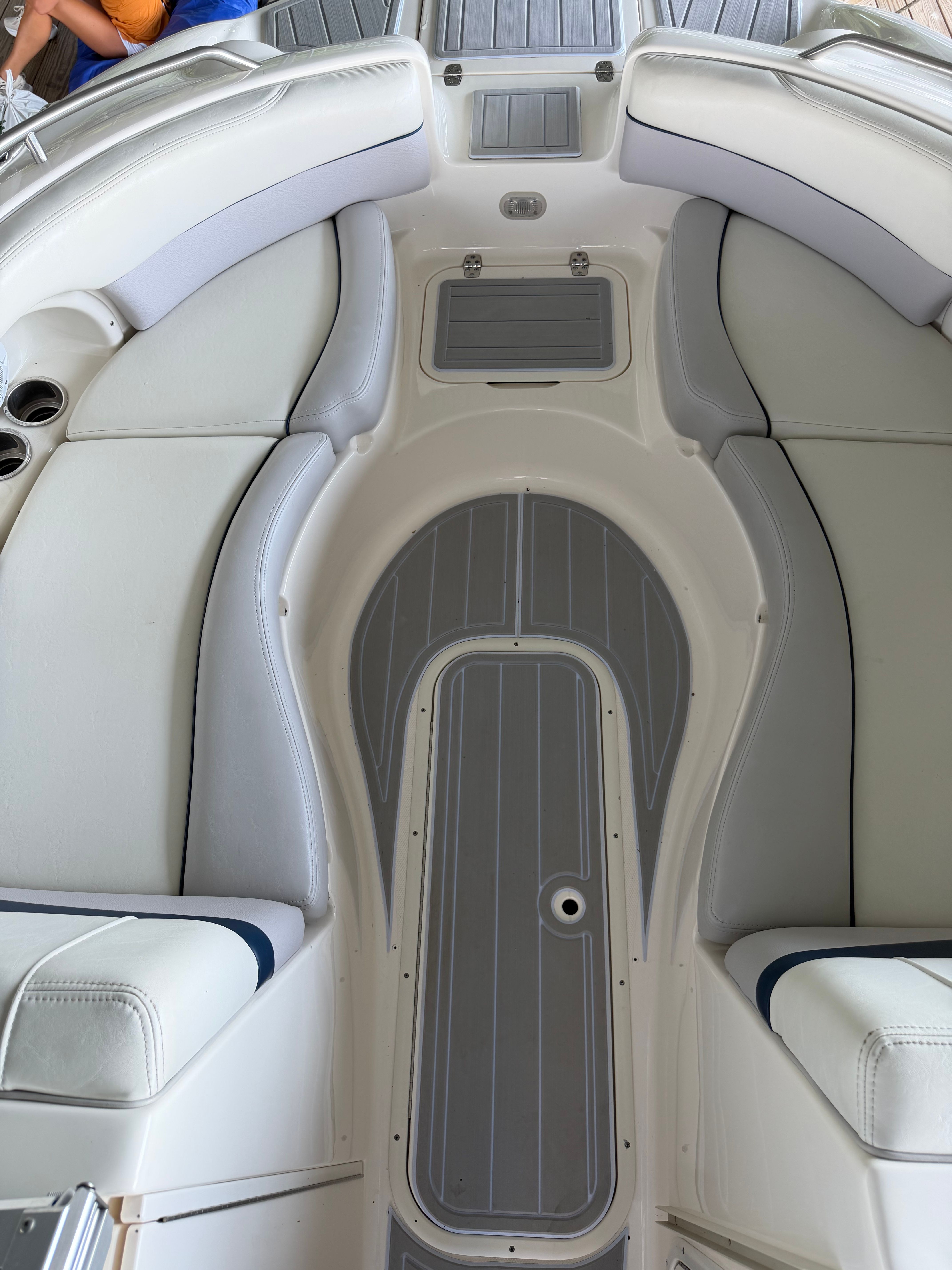 Interior of a 2010 Bryant 255 boat with gray upholstery.