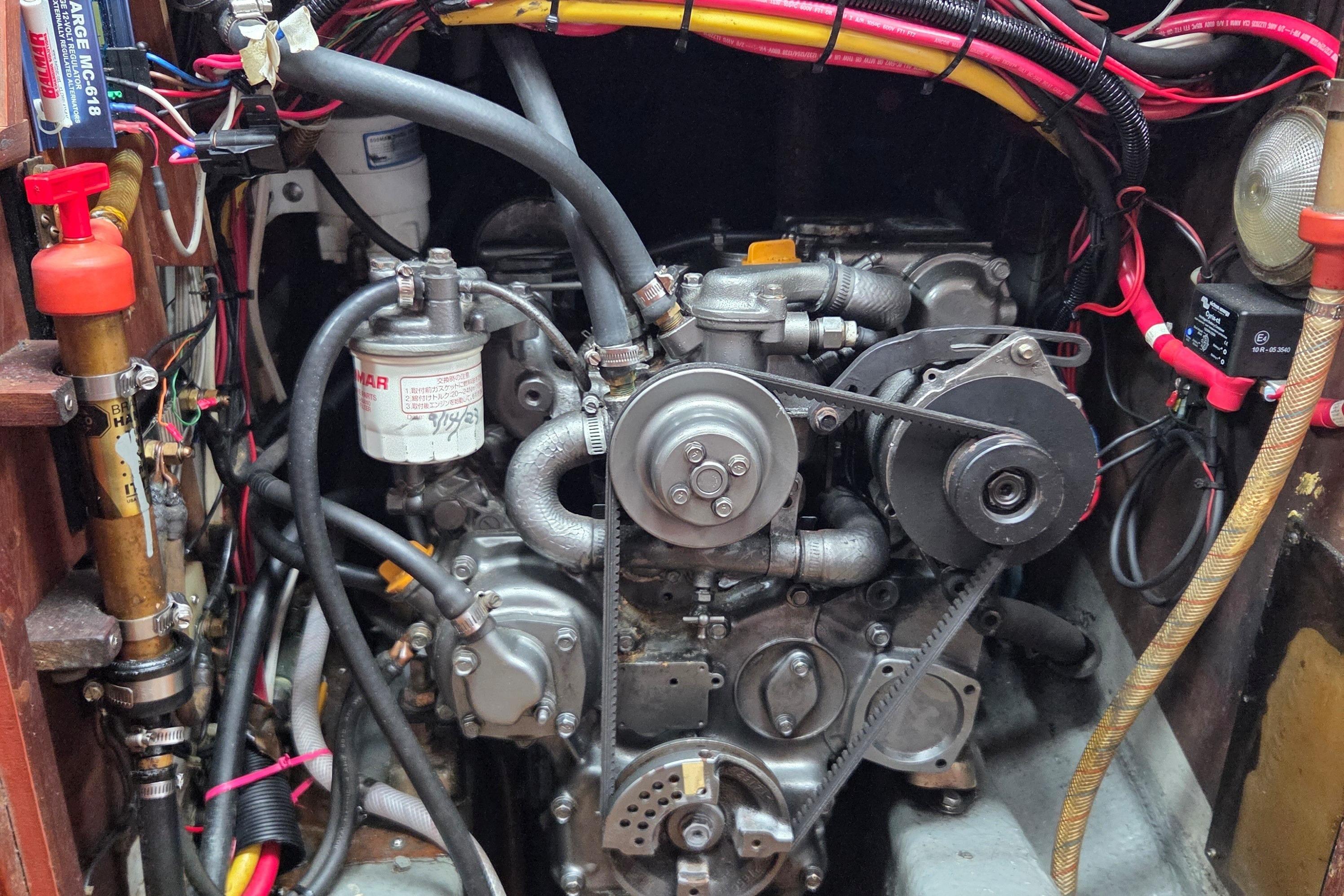 Engine compartment of a 1983 Pacific Seacraft 34 sailboat, showcasing detailed wiring and components.