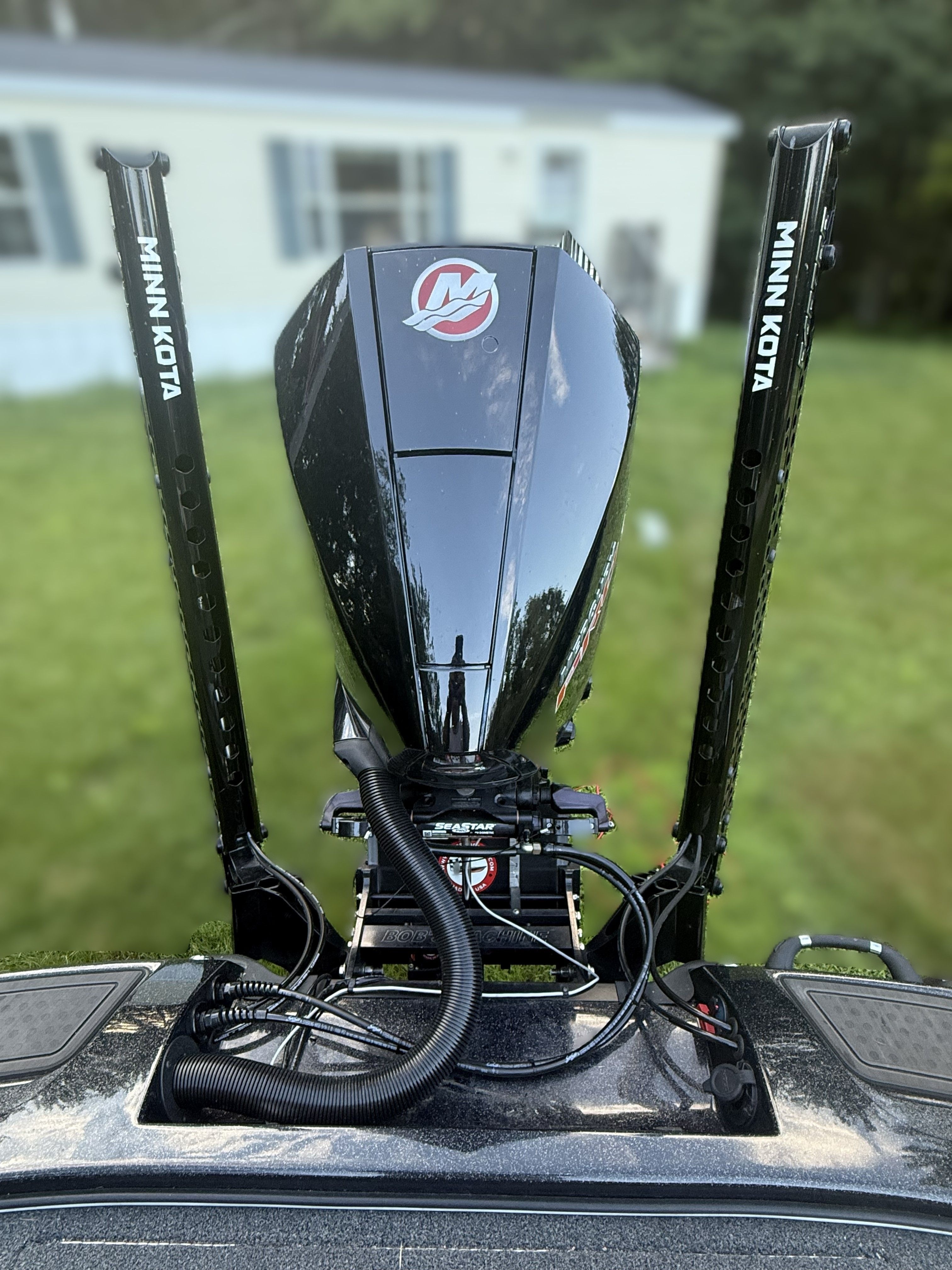 A 2023 Nitro Z21 XL Pro with Minn Kota motors, parked on a lawn.