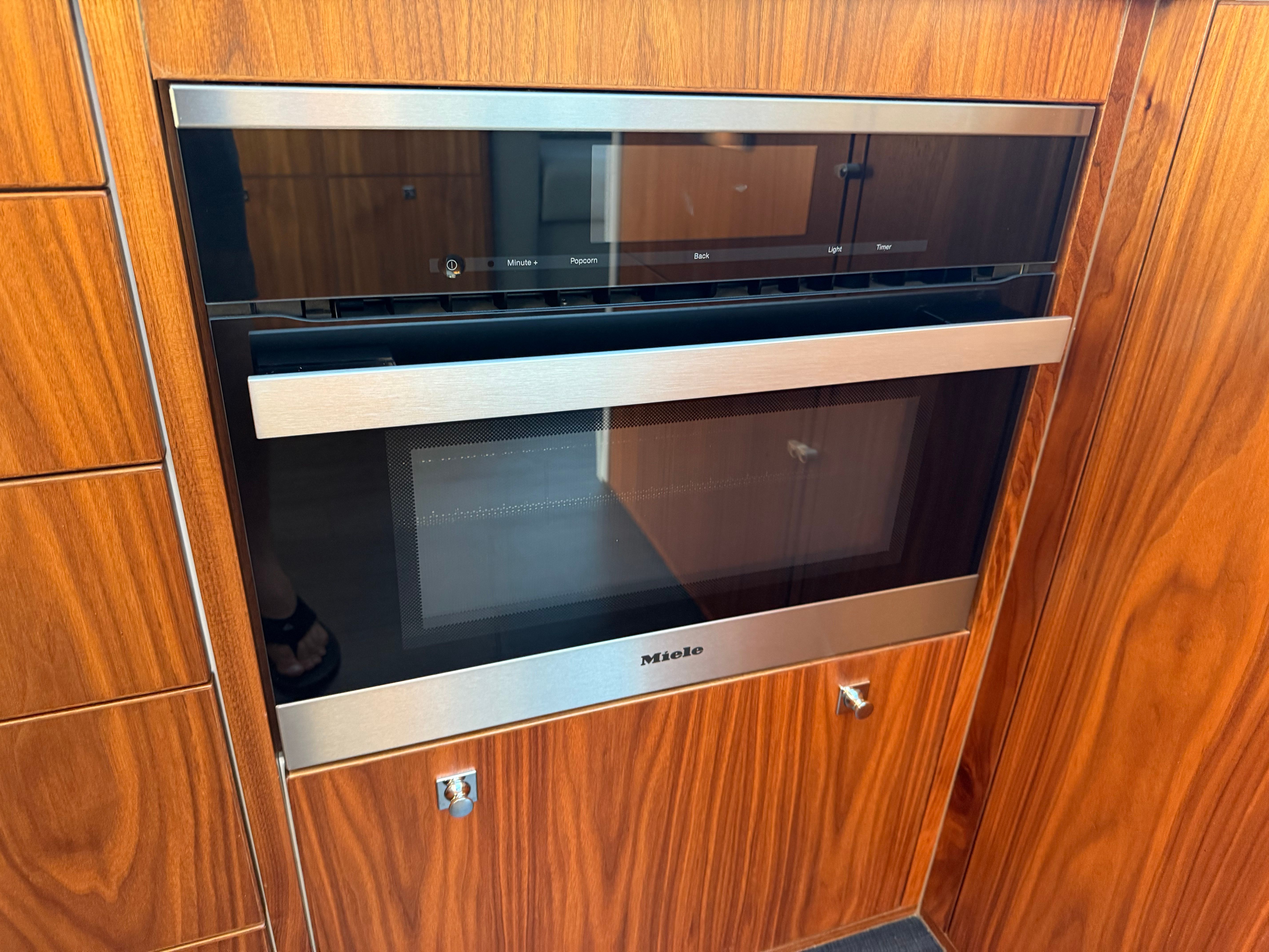 Built-in Miele microwave in 2022 Riviera 6000 Sport Yacht Platinum kitchen.