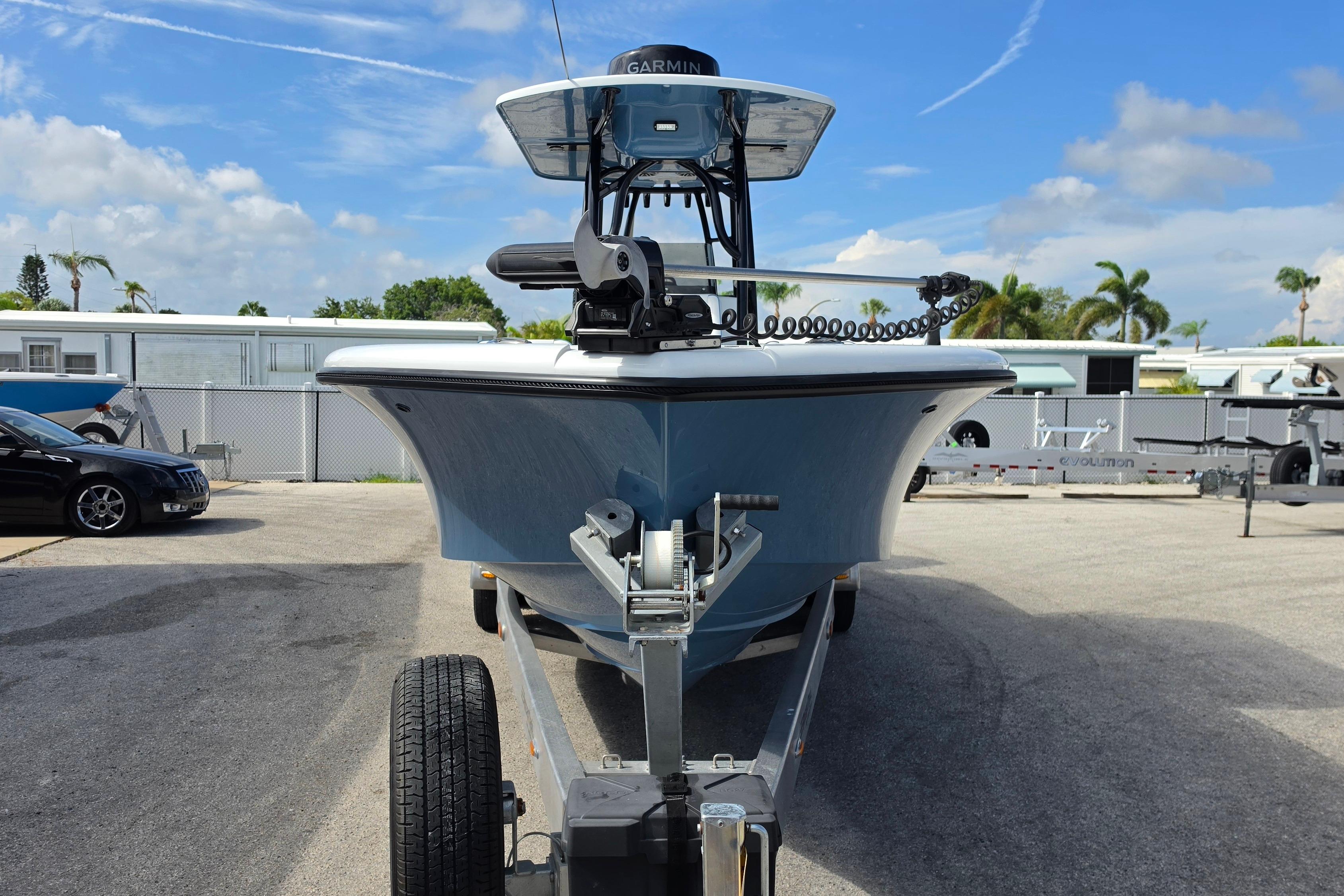 2025 Yellowfin 26 Hybrid boat on trailer, parked outdoors under a clear sky.