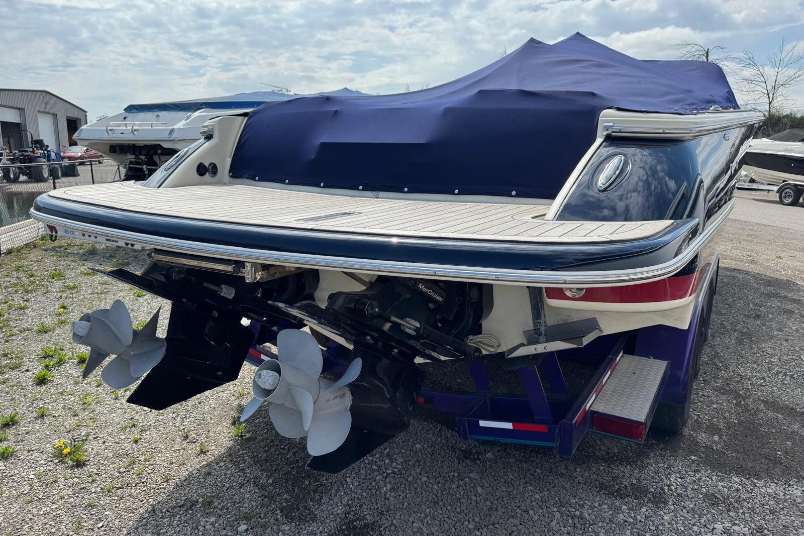2013 Chris-Craft Launch 28 boat with covered deck and dual propellers.