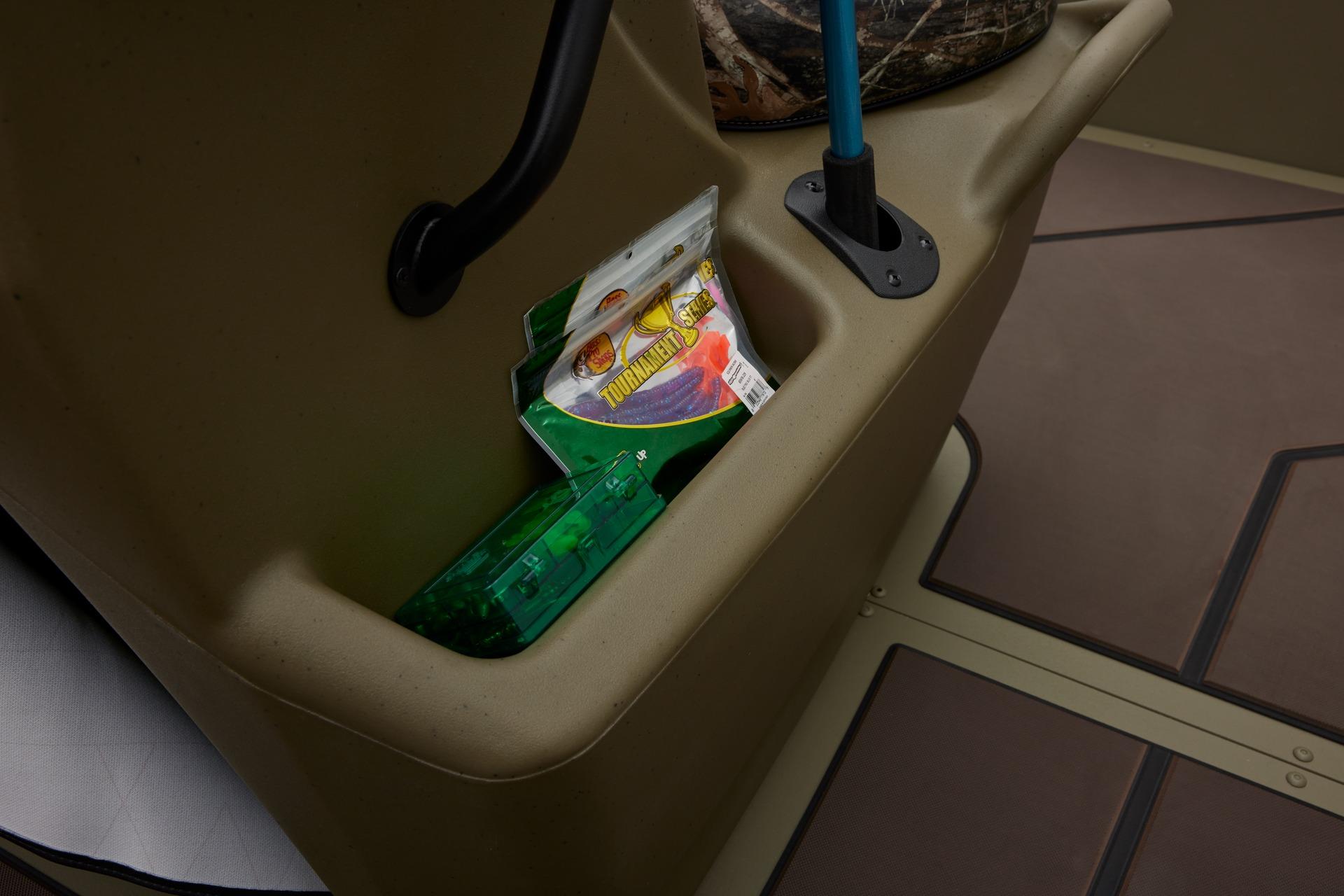 Storage compartment in 2024 Tracker Grizzly 2072 CC boat with fishing gear.