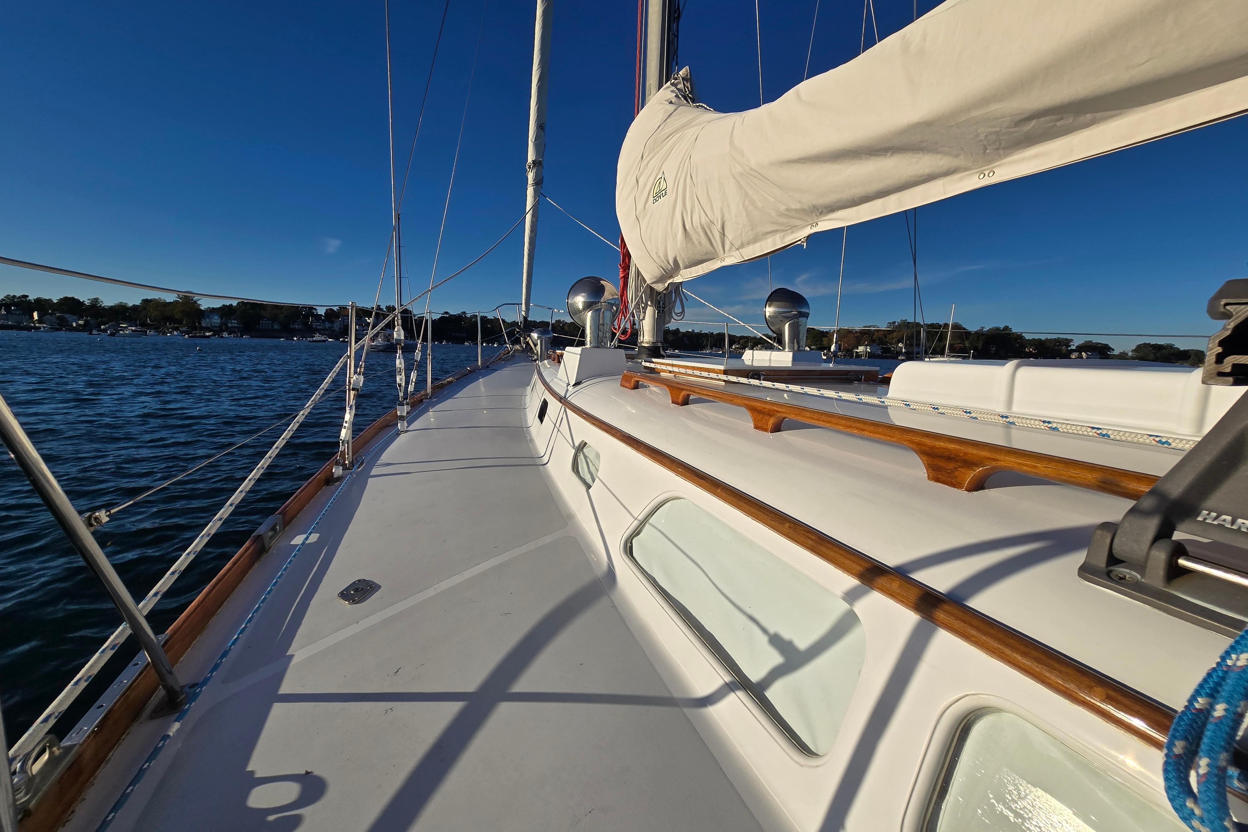 1970 Hinckley Bermuda 40 sailboat deck with clear skies and calm waters.