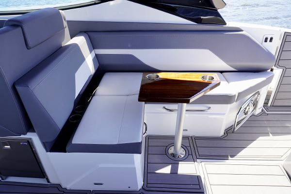 Luxurious seating area on 2020 Cruisers Yachts 38 GLS OB with sleek table design.