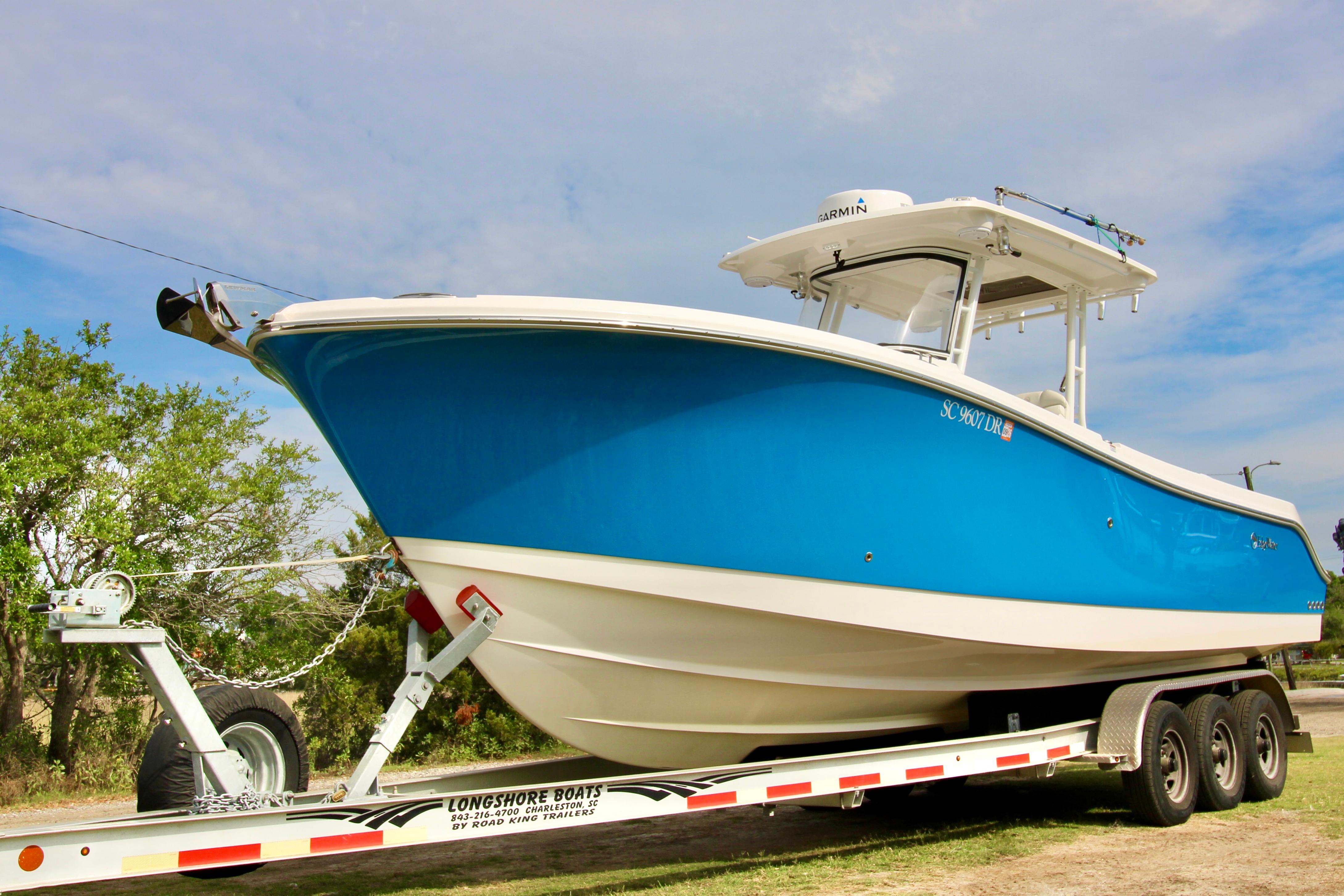 2022 Edgewater 280CC boat on trailer, featuring a sleek blue hull design.