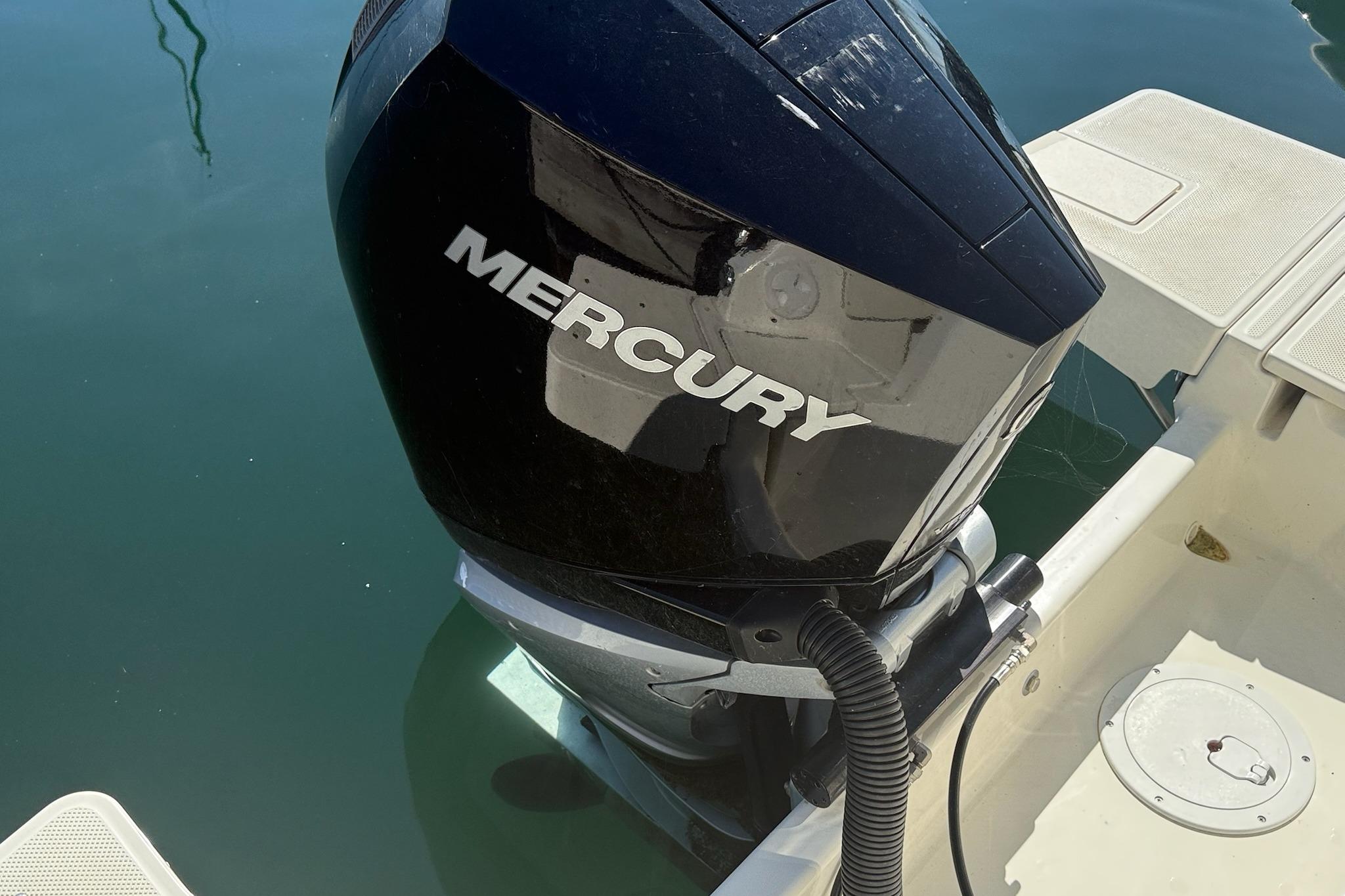 2024 Bayliner Trophy T25 Pilothouse with Mercury outboard engine on calm water.