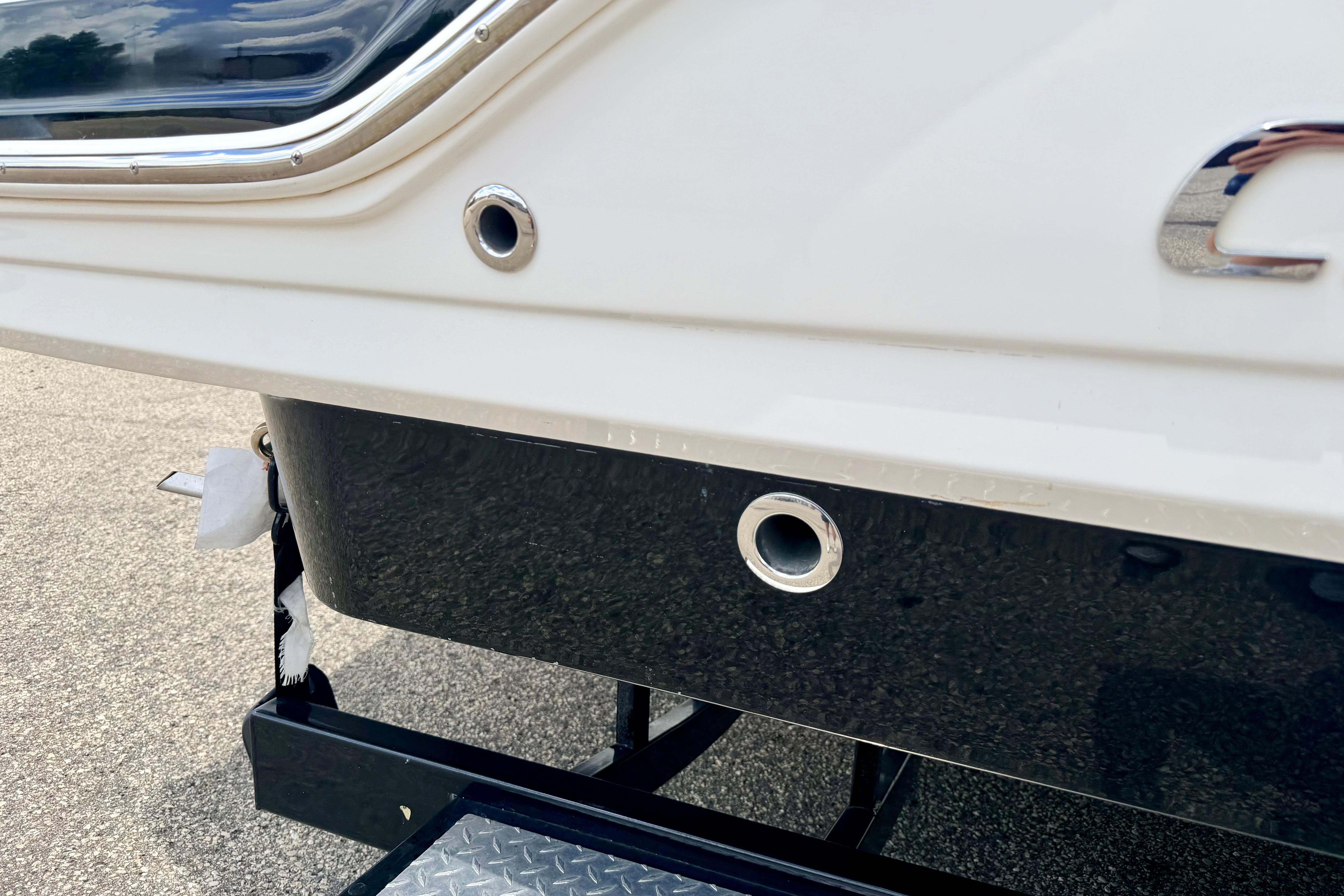 Rear view of 2015 Chaparral Sunesta 264 boat on trailer, showcasing hull details.