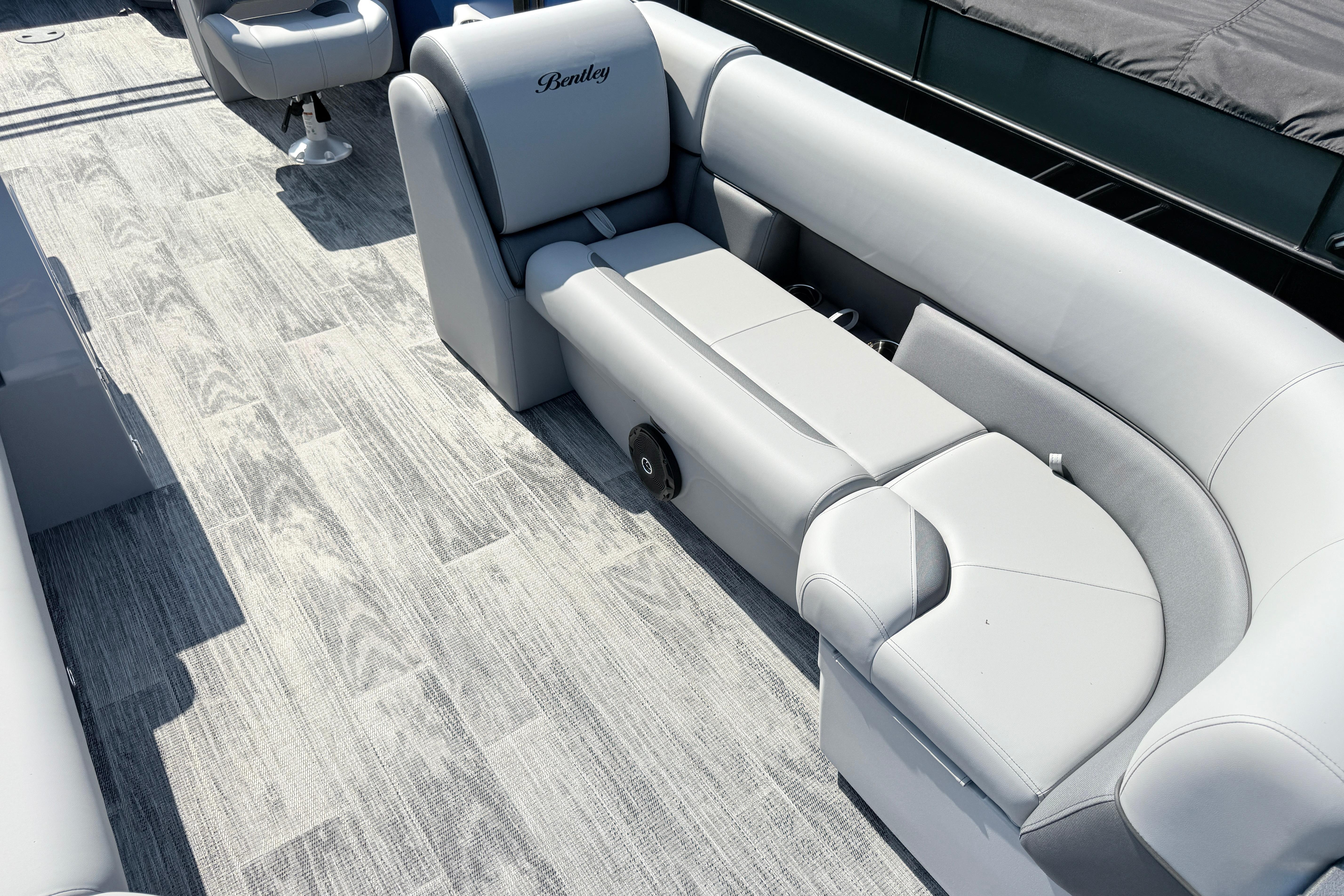 Luxurious seating on 2027 Bentley Pontoons Legacy 240 Navigator with elegant flooring.