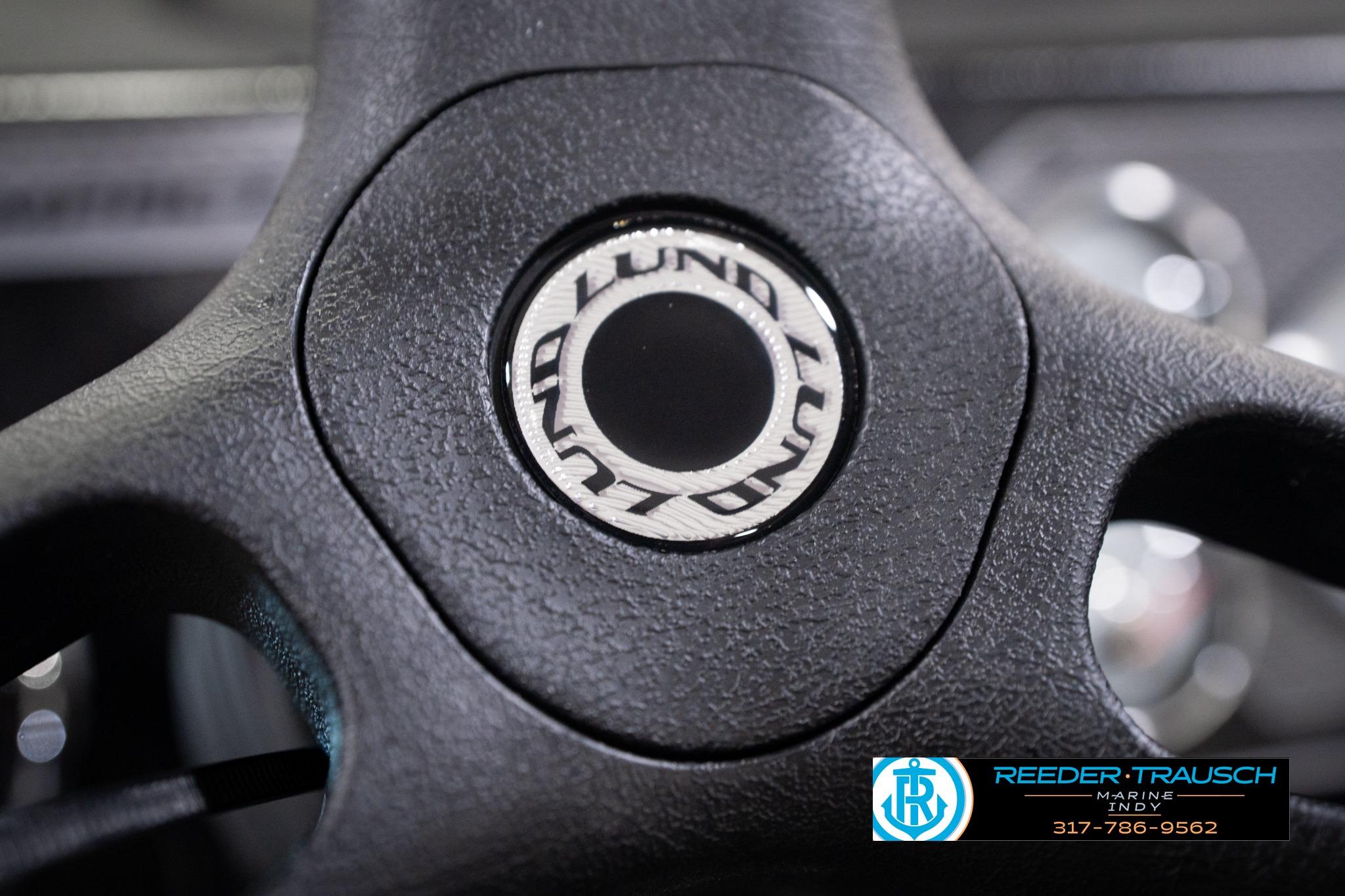 Close-up of 2026 Lund 1775 Impact XS SS steering wheel with logo.