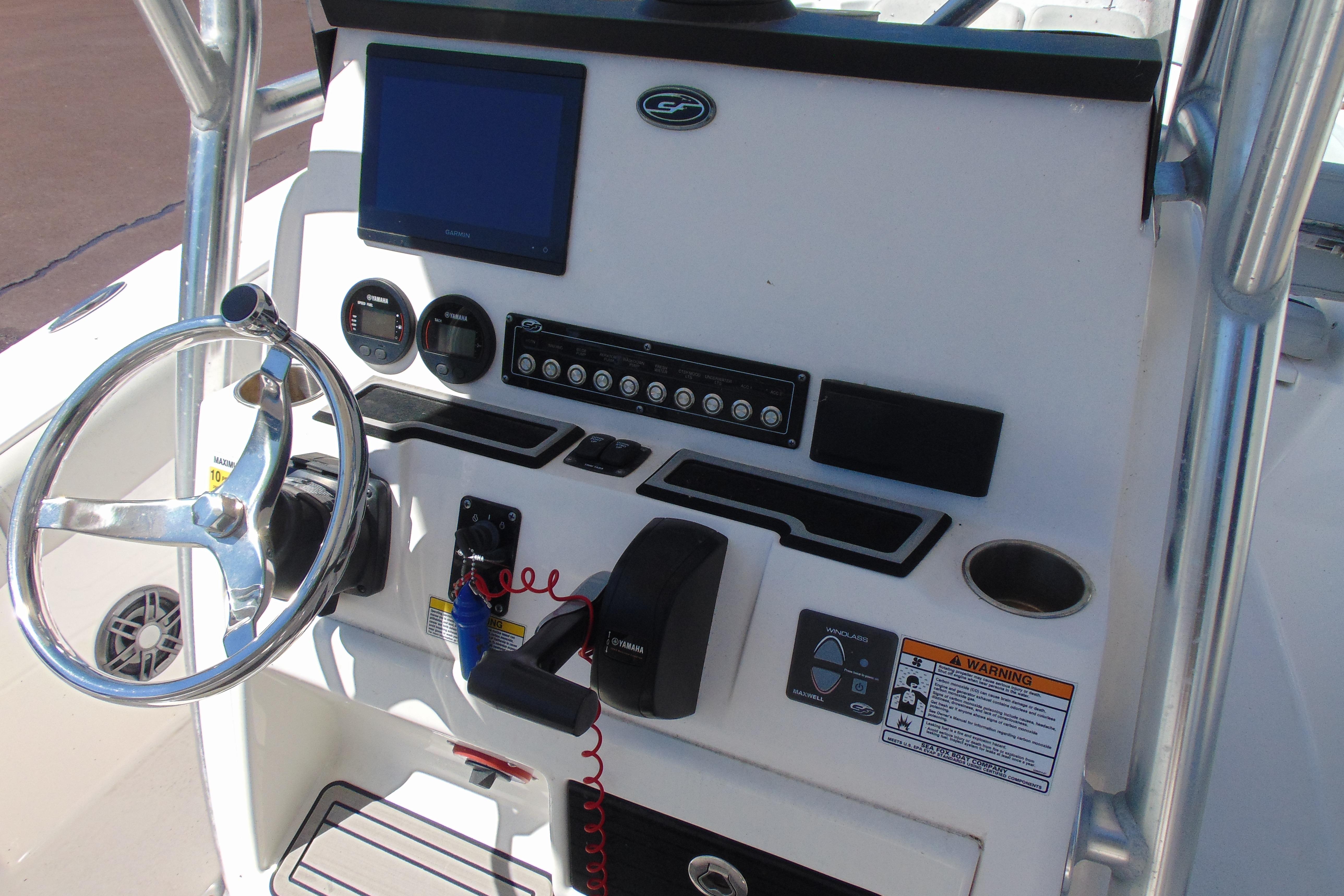 2022 Sea Fox 248 Commander boat dashboard with steering wheel and control panel.