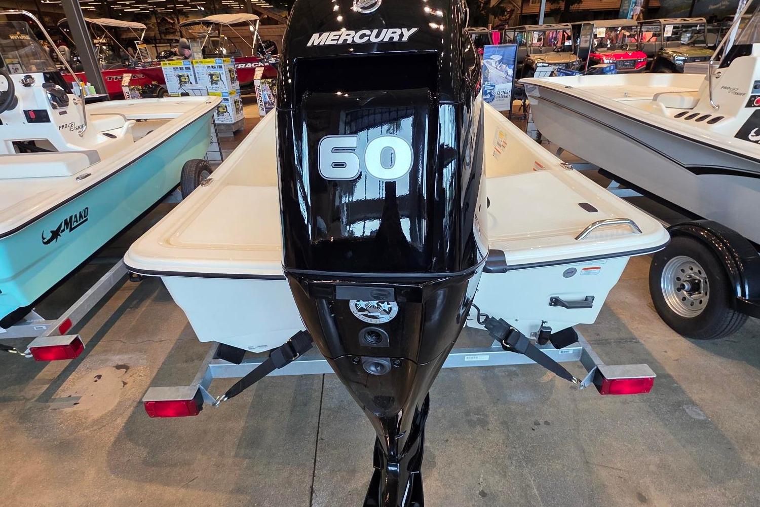 2026 Mako Pro Skiff 15 CC with Mercury 60 engine displayed in showroom.