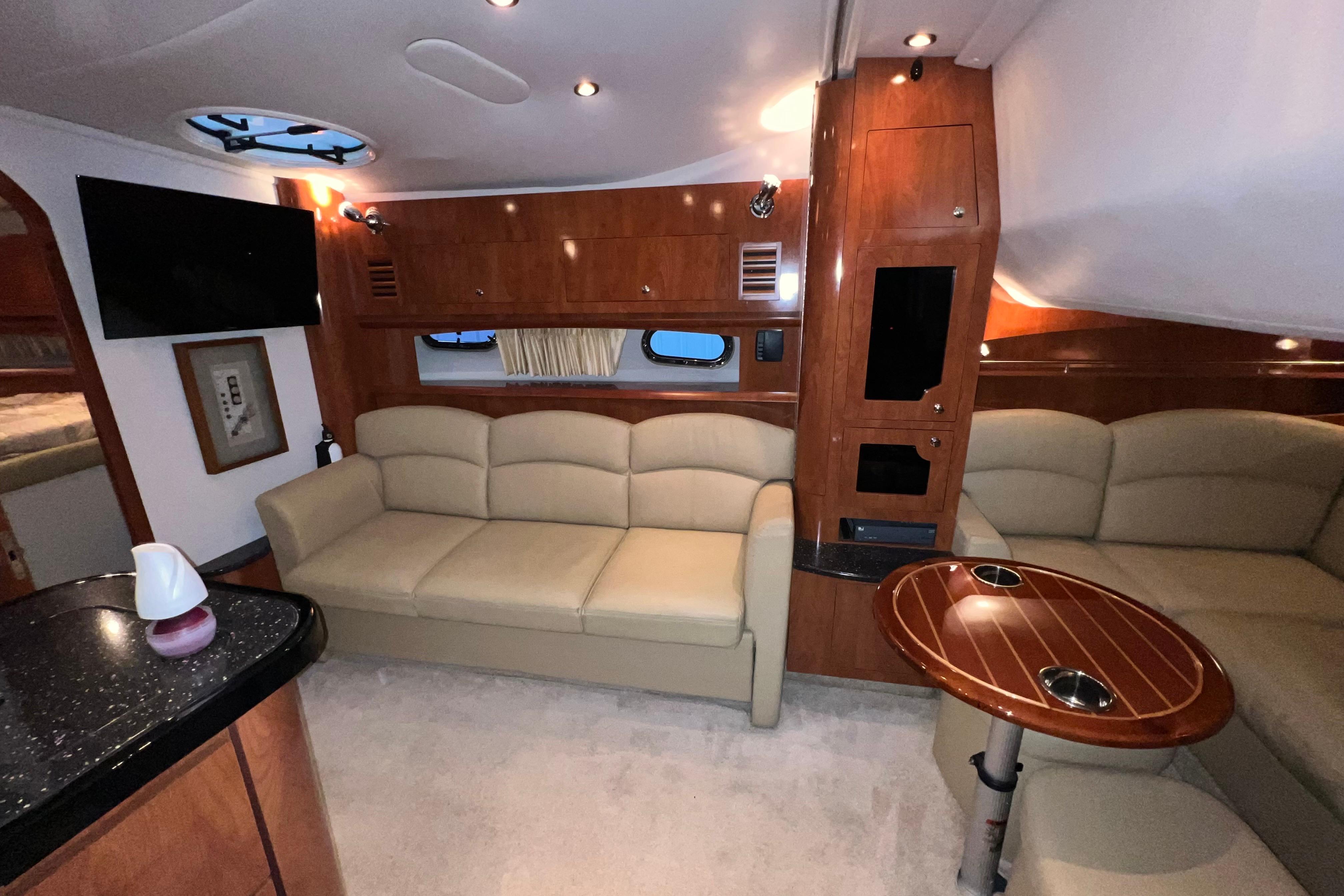 Interior of 2008 Four Winns 378 Vista yacht with beige seating and wood accents.