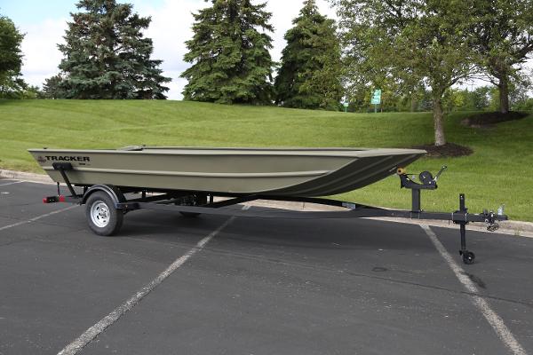 2025 Tracker GRIZZLY 1860 Utility boat on trailer in parking lot.