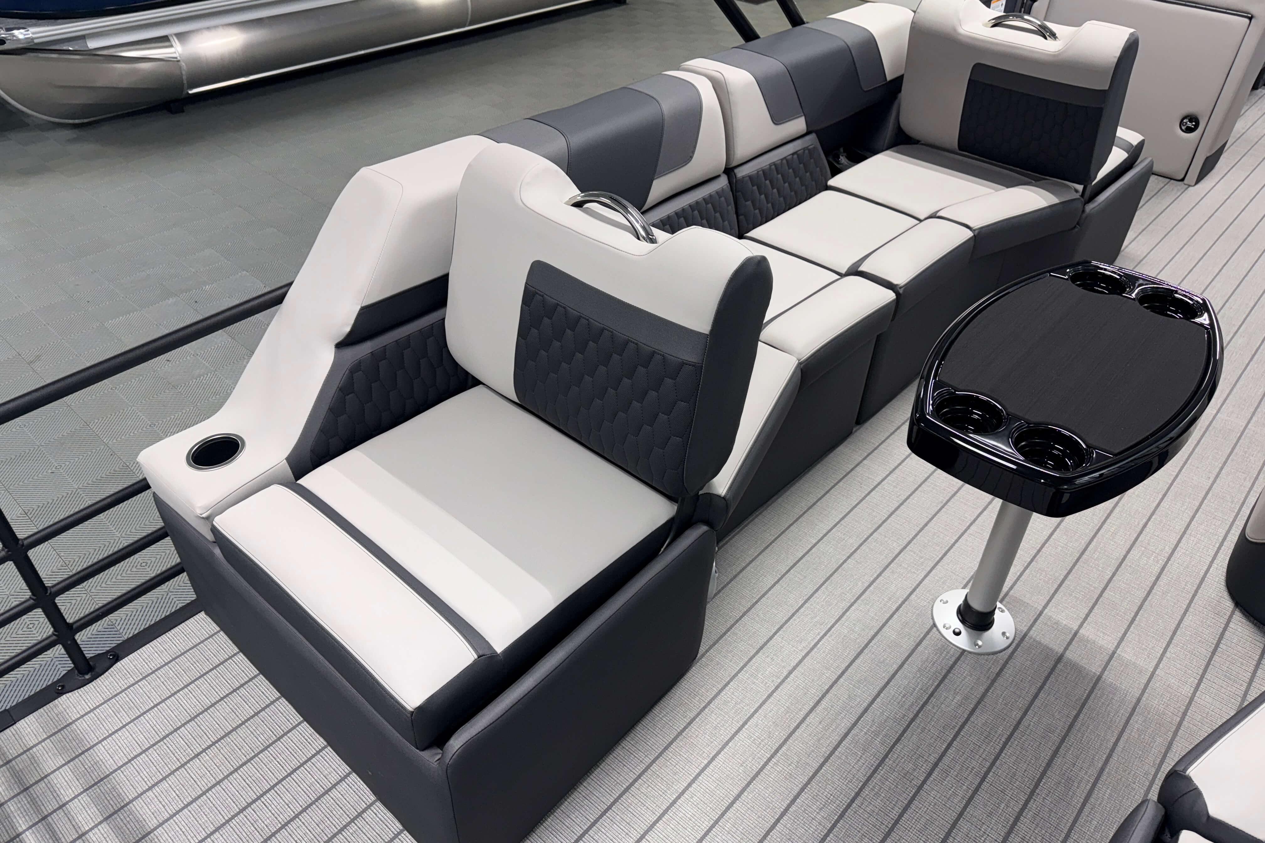 Luxurious seating on 2026 Sylvan L3 SLZ pontoon boat with modern design and cup holders.