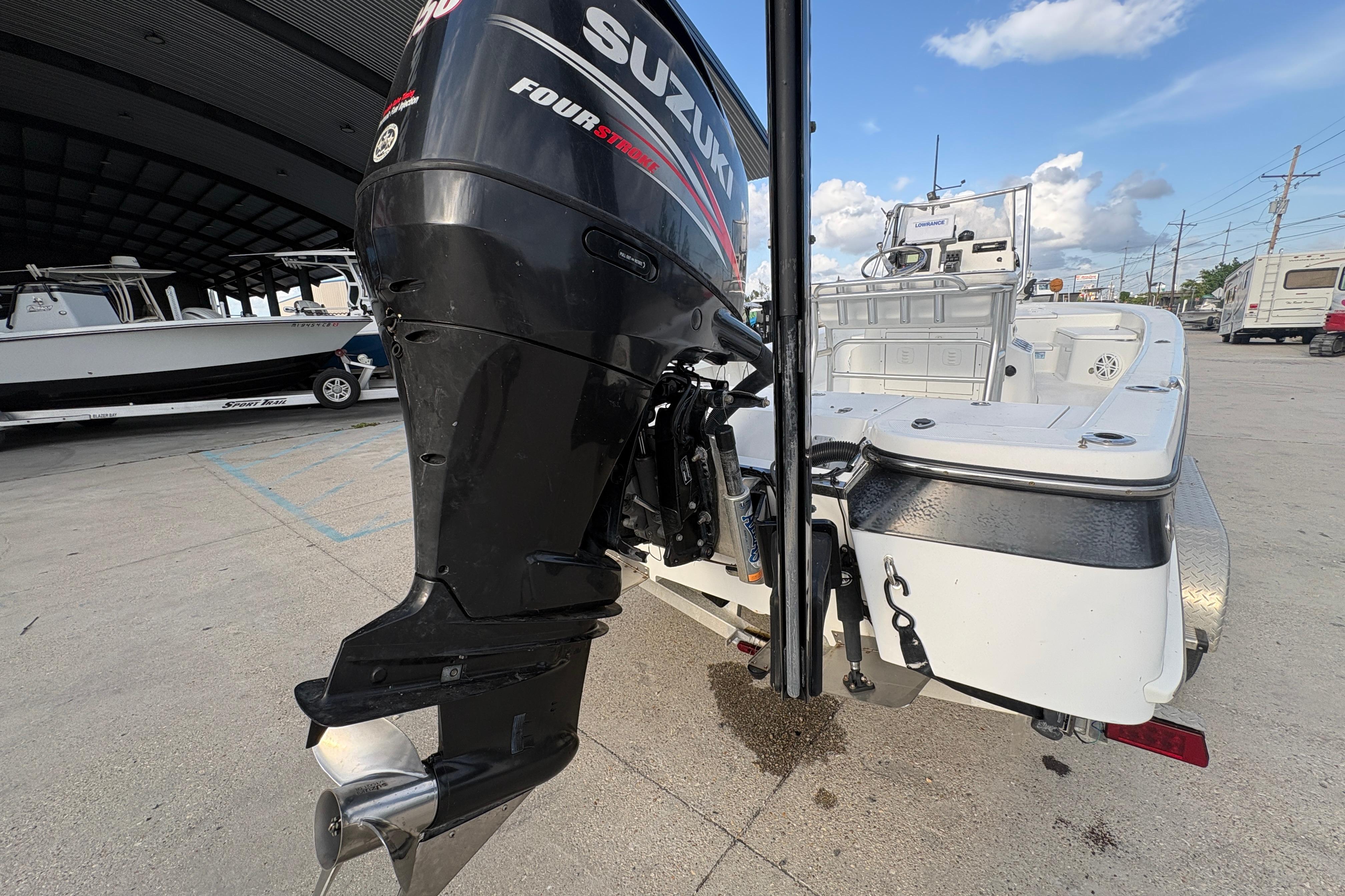 2012 BlackJack 224 boat with Suzuki Four Stroke outboard motor at a marina.