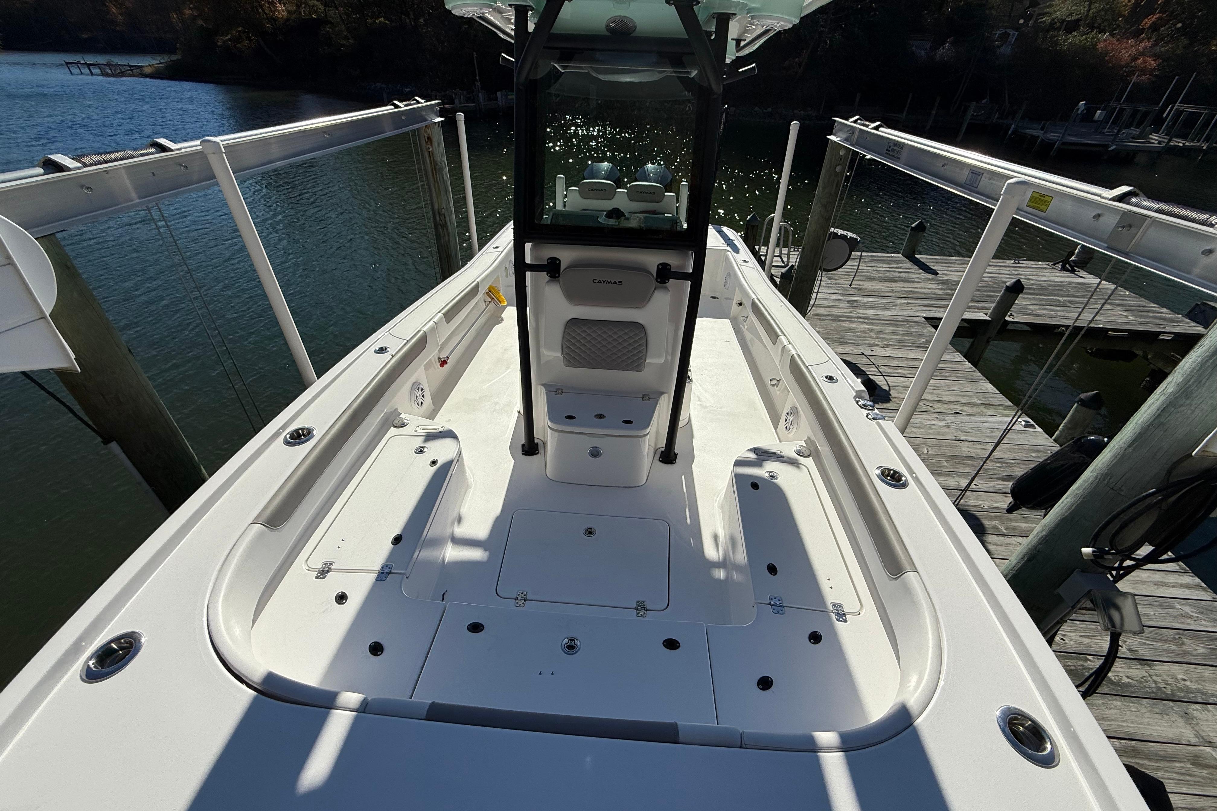 2023 Caymas 281 HB boat docked, showcasing spacious deck and sleek design.