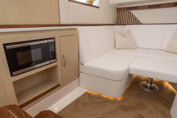Manufacturer Provided Image: Luxurious interior of 2026 Regal LX43 yacht with modern seating and built-in microwave.