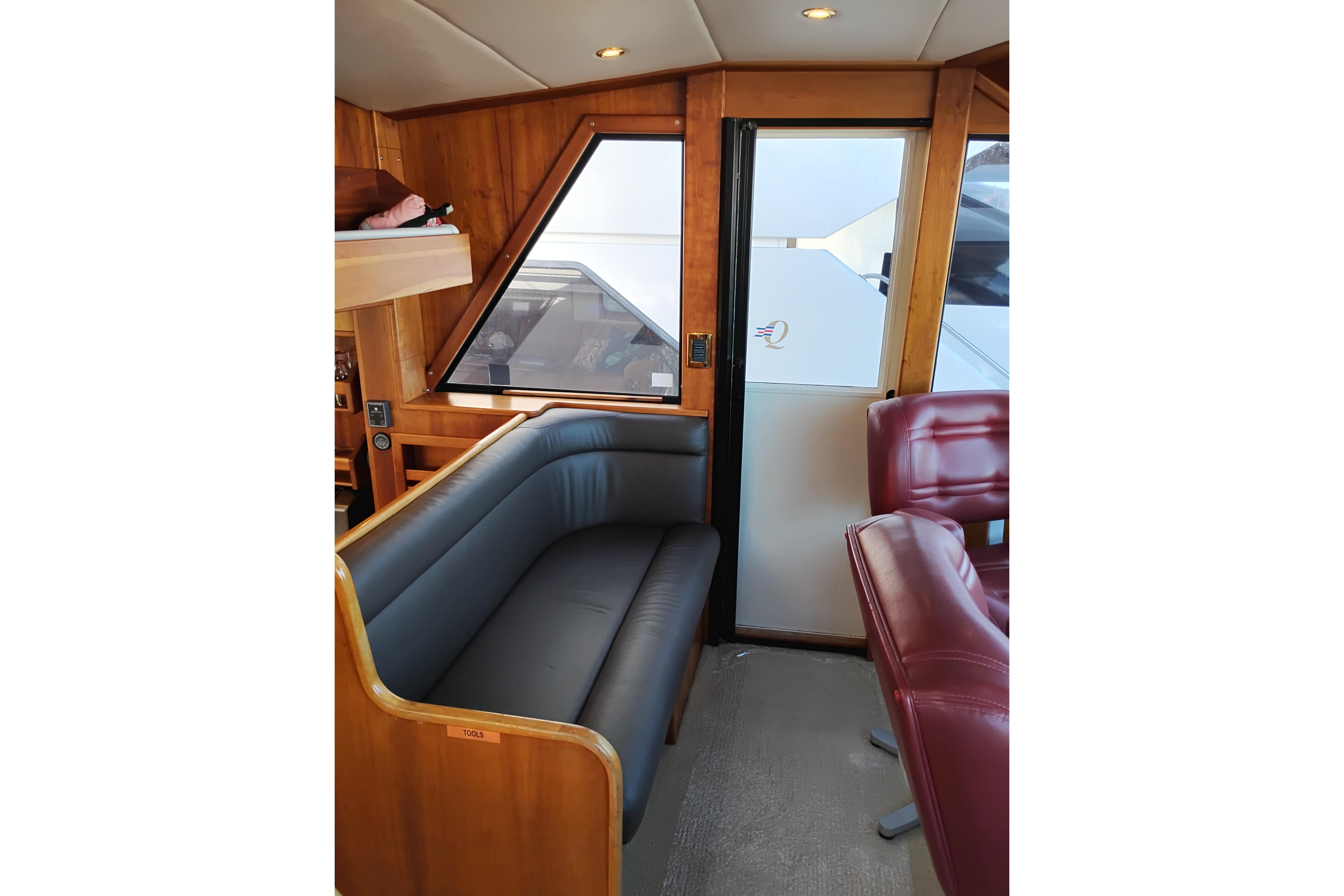 Interior of 2002 Canoe Cove 50 Pilothouse Motor Yacht with leather seating and wood paneling.