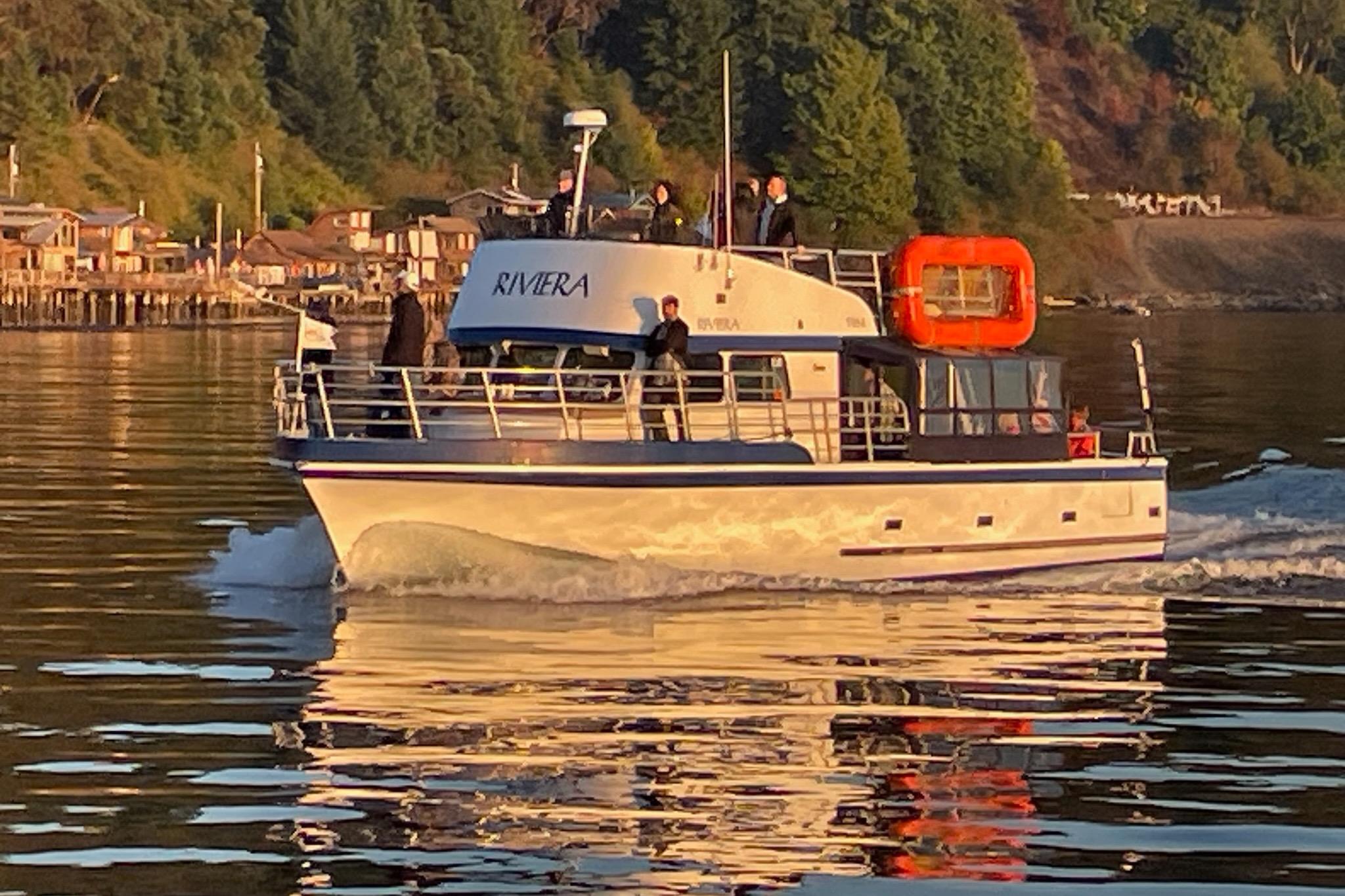 1964 Grandy Tour Boat cruising on calm water near a forested shoreline.