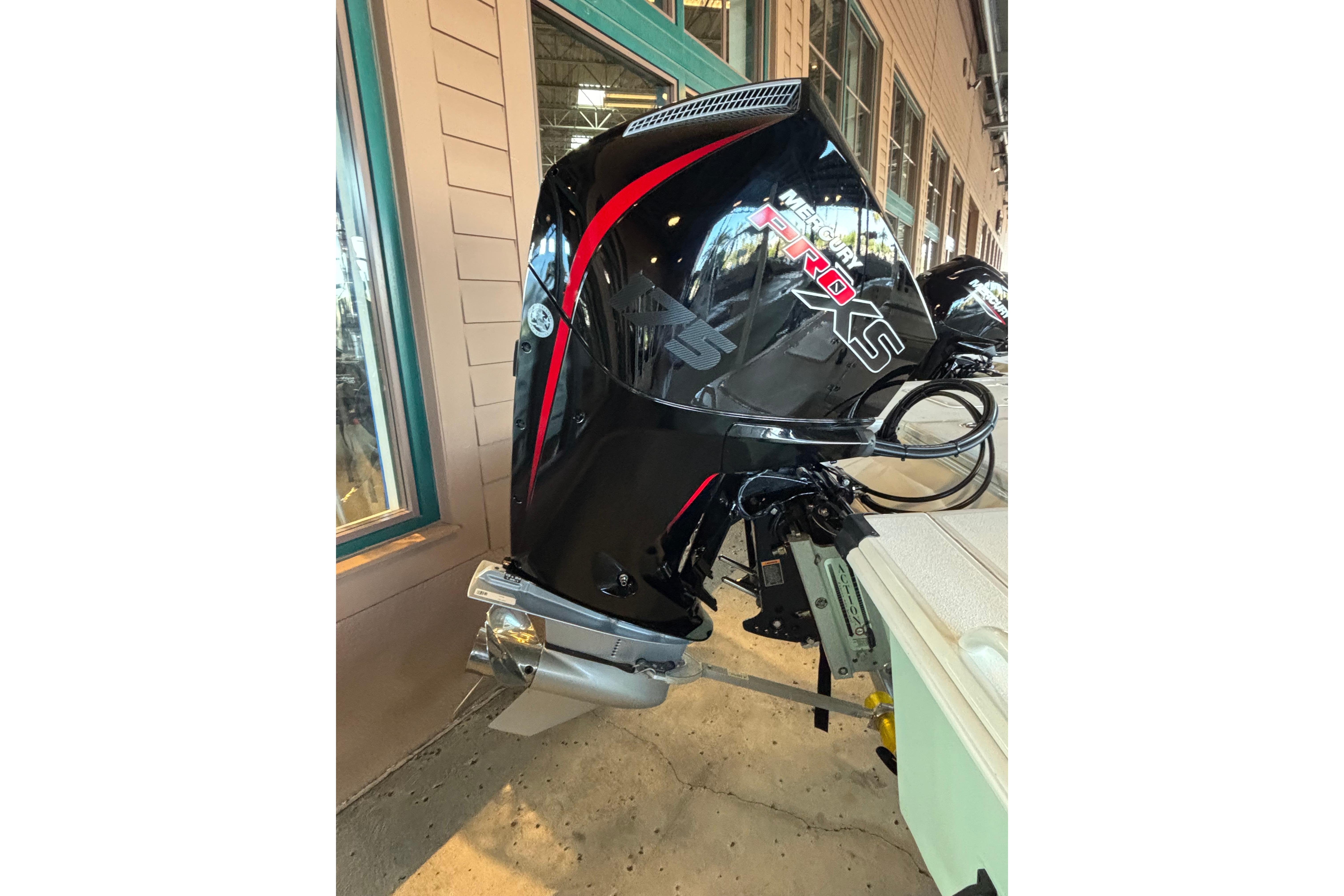 Outboard motor on a 2026 Mako 18 Pro Skiff, displayed indoors.