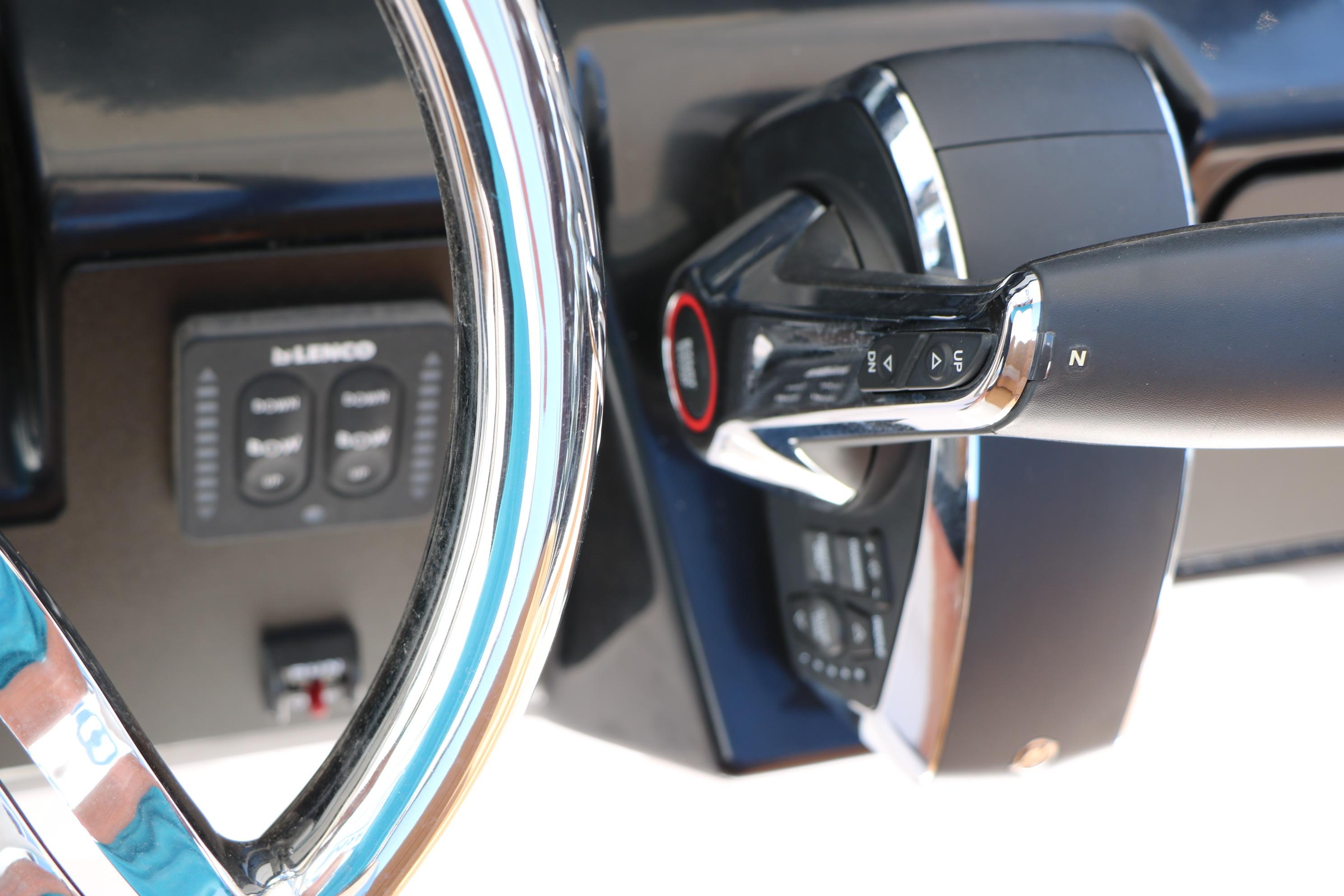 Close-up of 2026 Robalo 246 Cayman steering wheel and throttle controls.