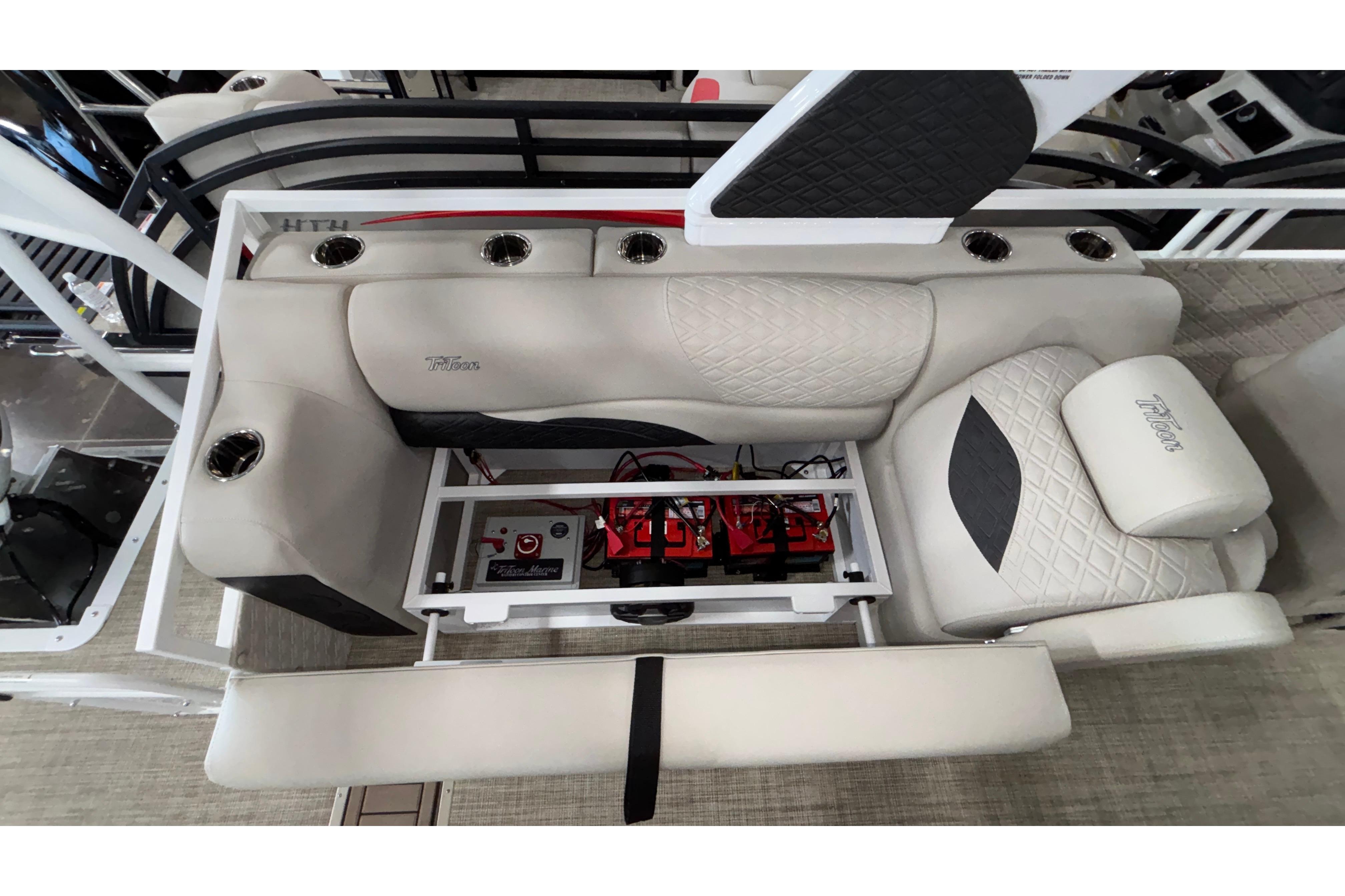 Interior view of 2026 JC Sporttoon 26TT boat, featuring luxurious seating and integrated storage.