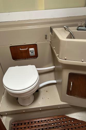 1983 O'Day 39 yacht bathroom with toilet and sink, featuring wood accents.