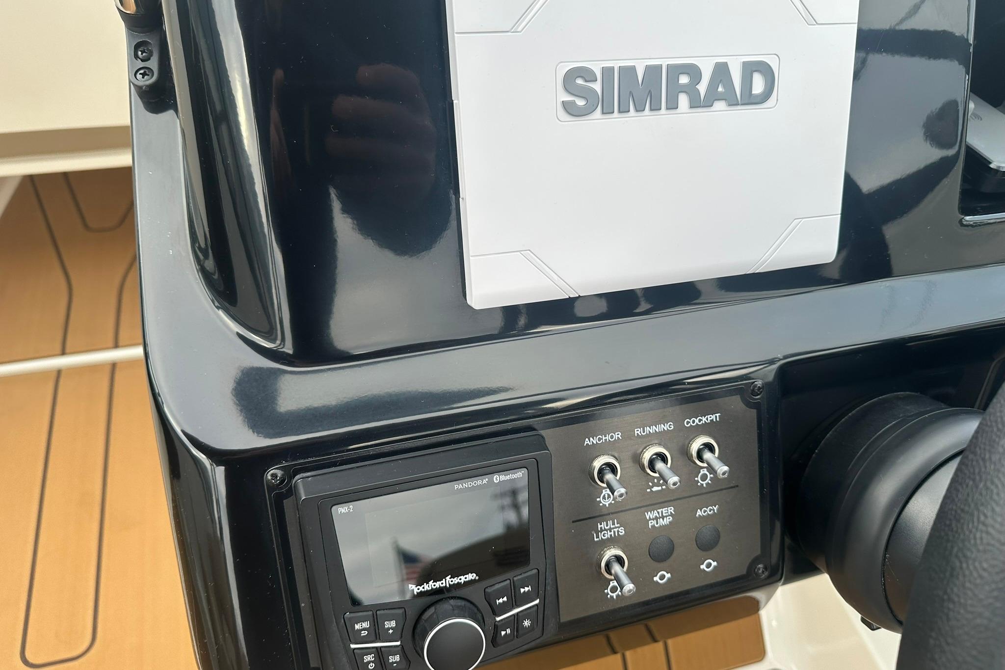 Control panel of 2026 Bayliner V20 boat with Simrad system and switches.