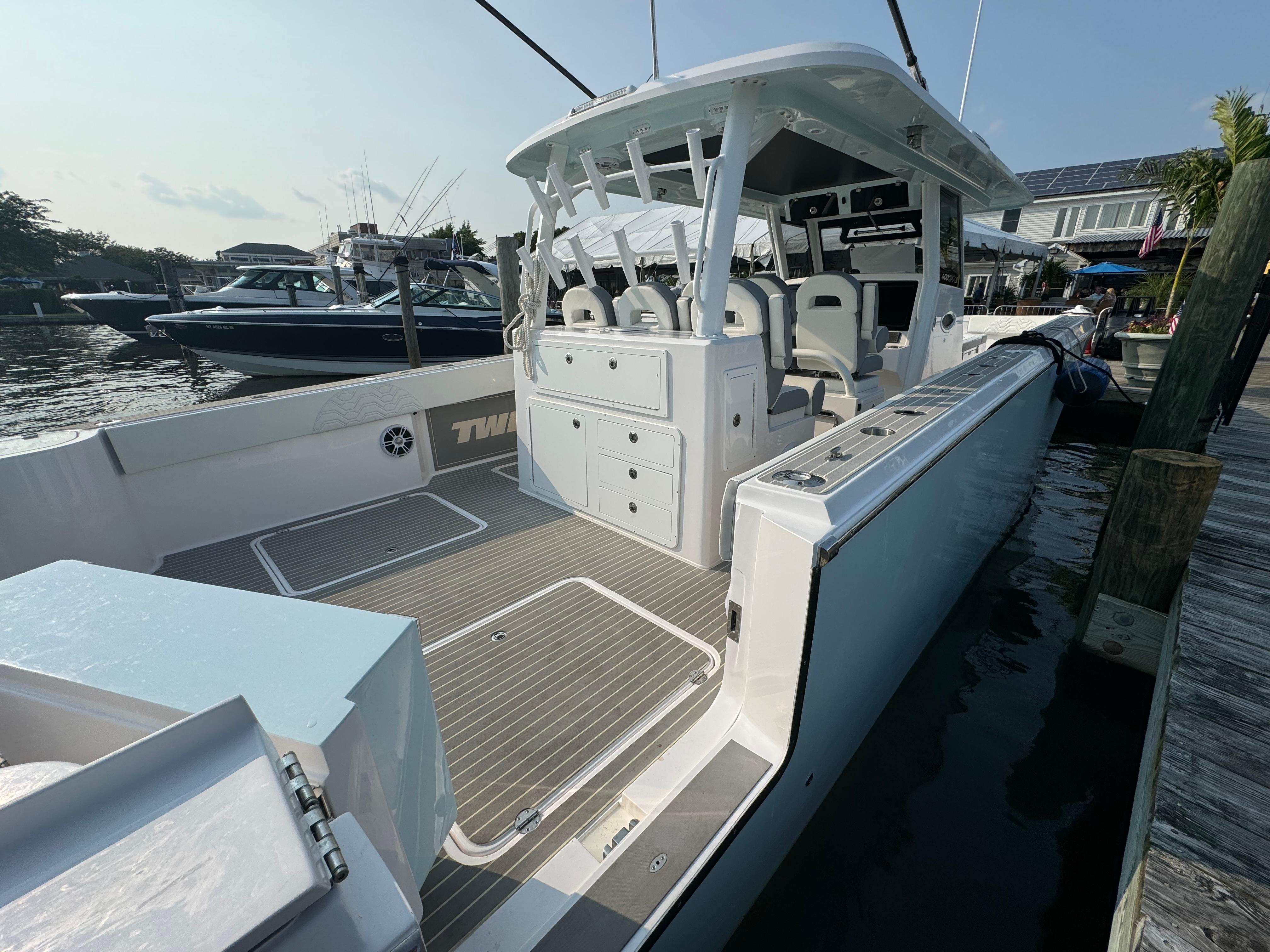 2025 Twin Vee 400 GFX boat docked, showcasing spacious deck and modern design.