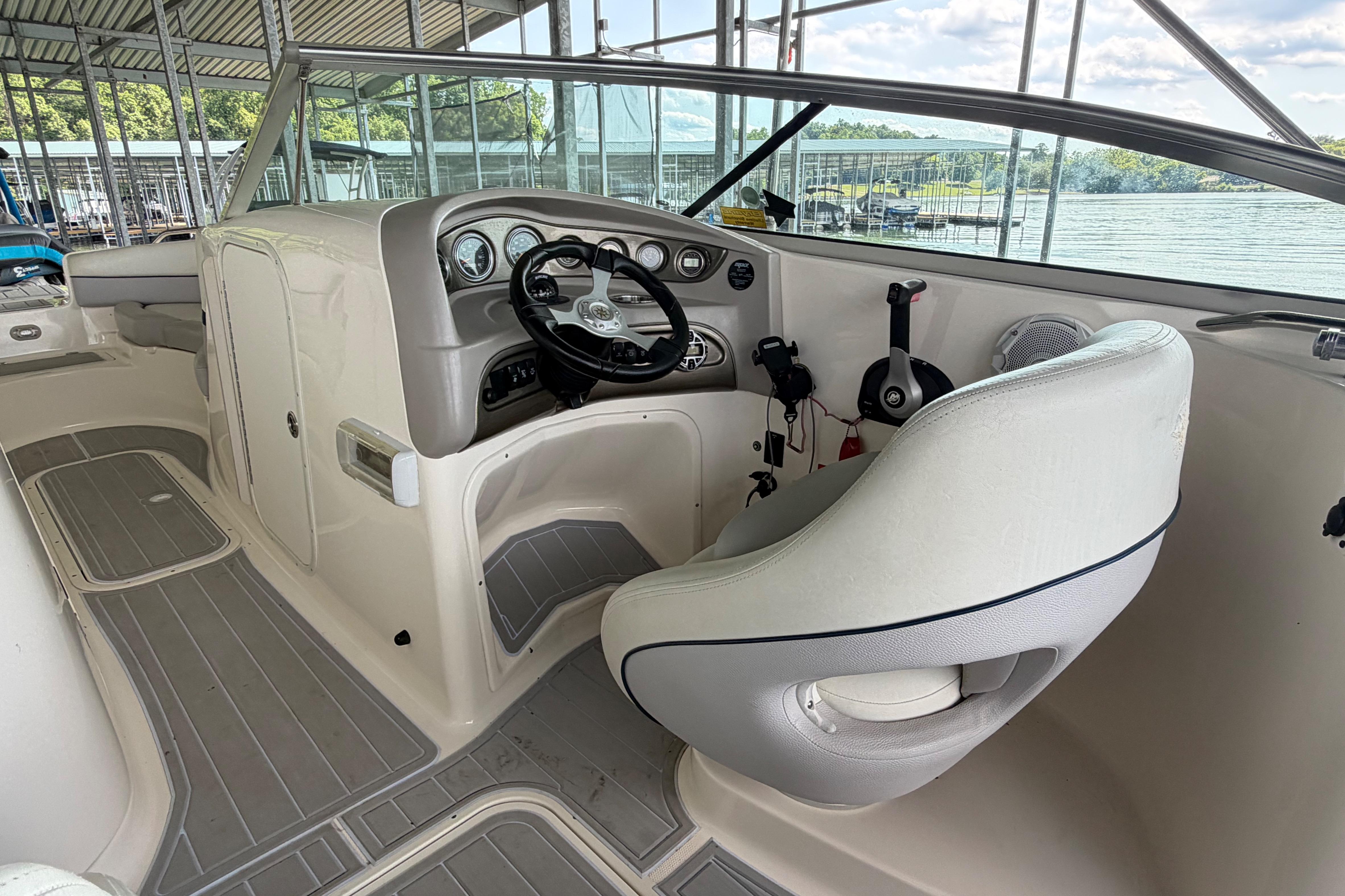 Interior of a 2010 Bryant 255 boat with steering wheel and dashboard.