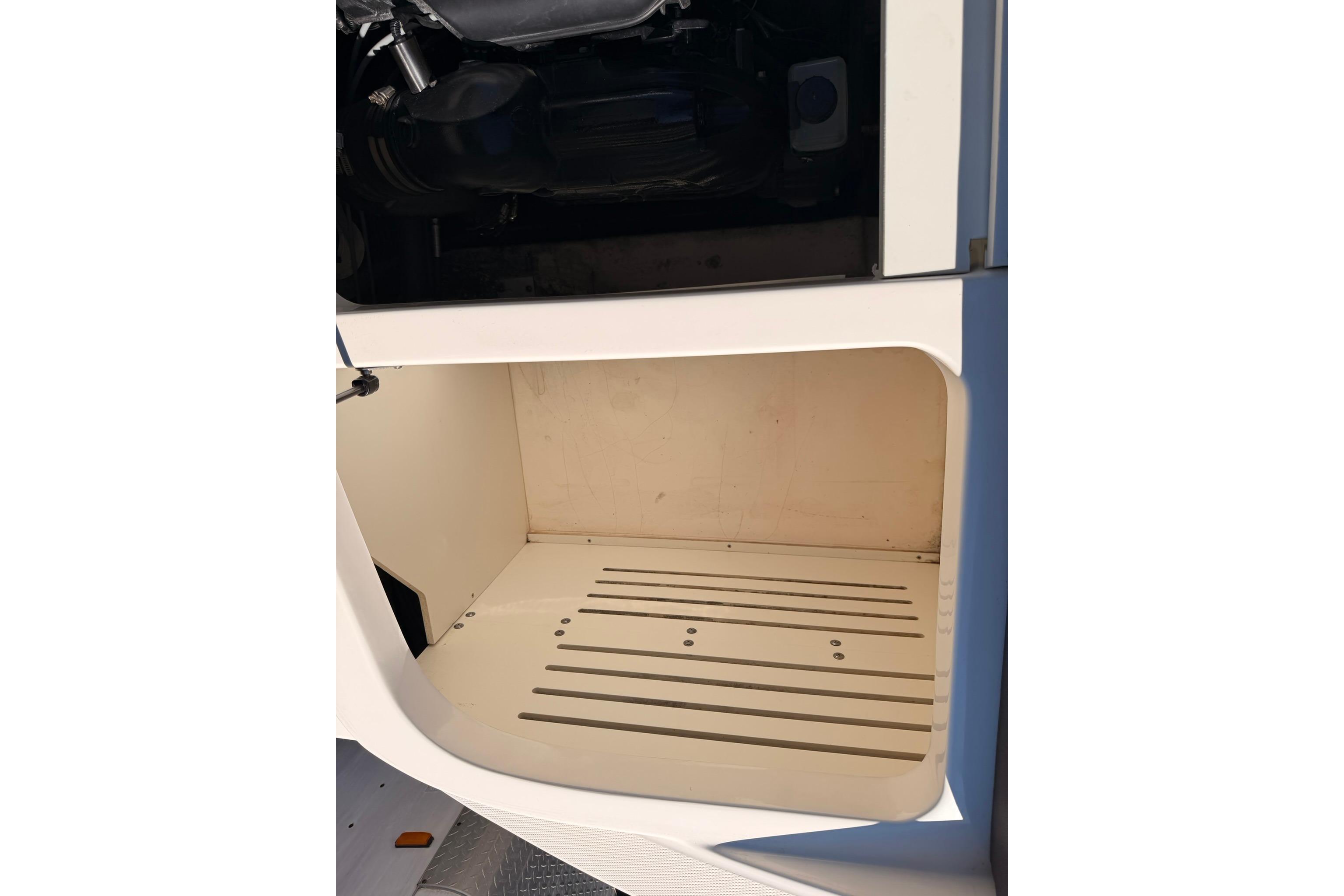 Open storage compartment in 2016 Sea Ray SPX 210 boat.