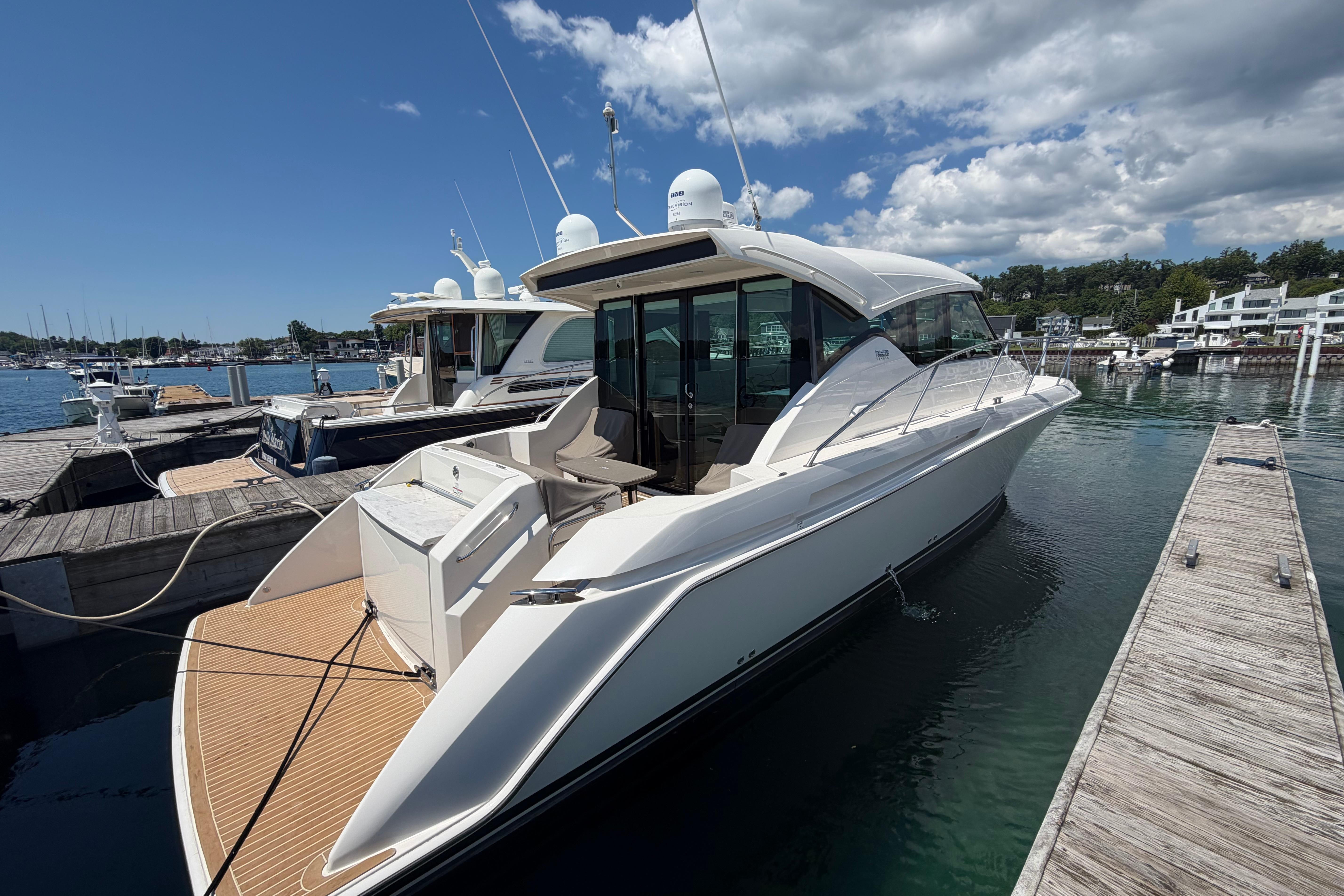 2016 Tiara Yachts C39 Coupe docked at marina under clear blue sky.