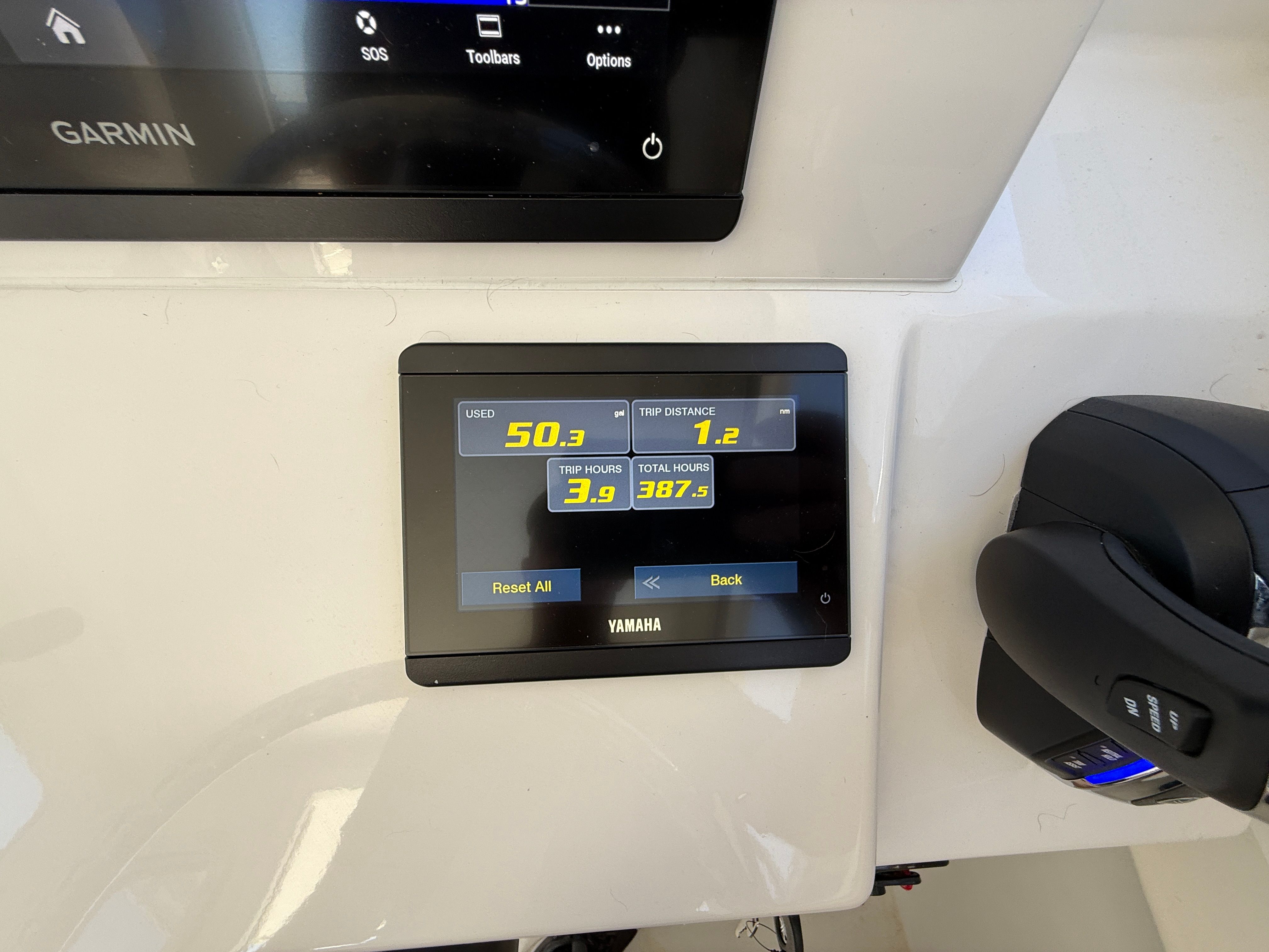 A Yamaha display shows fuel usage and trip data.