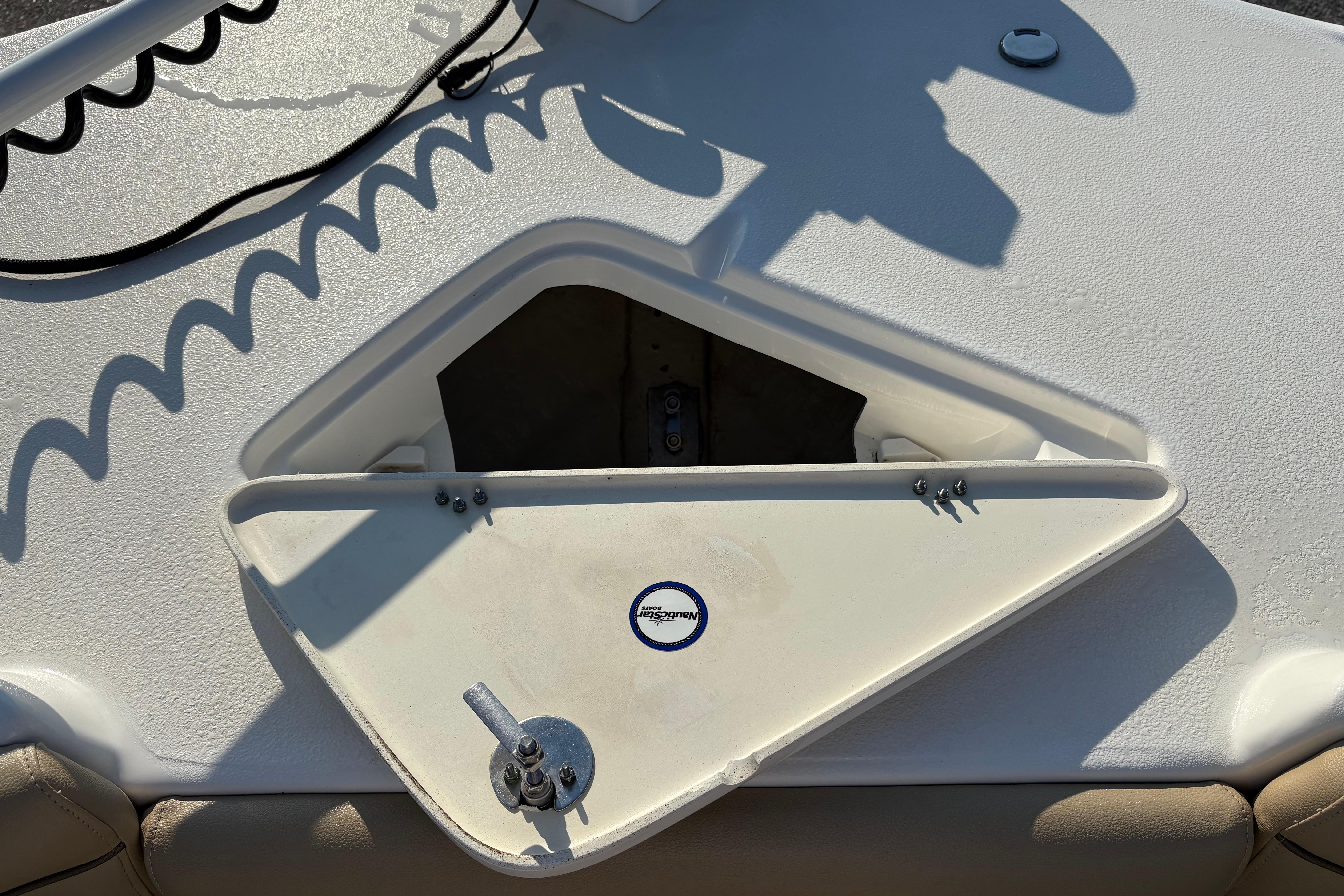 Open storage compartment on 2019 NauticStar 231 Hybrid boat deck.