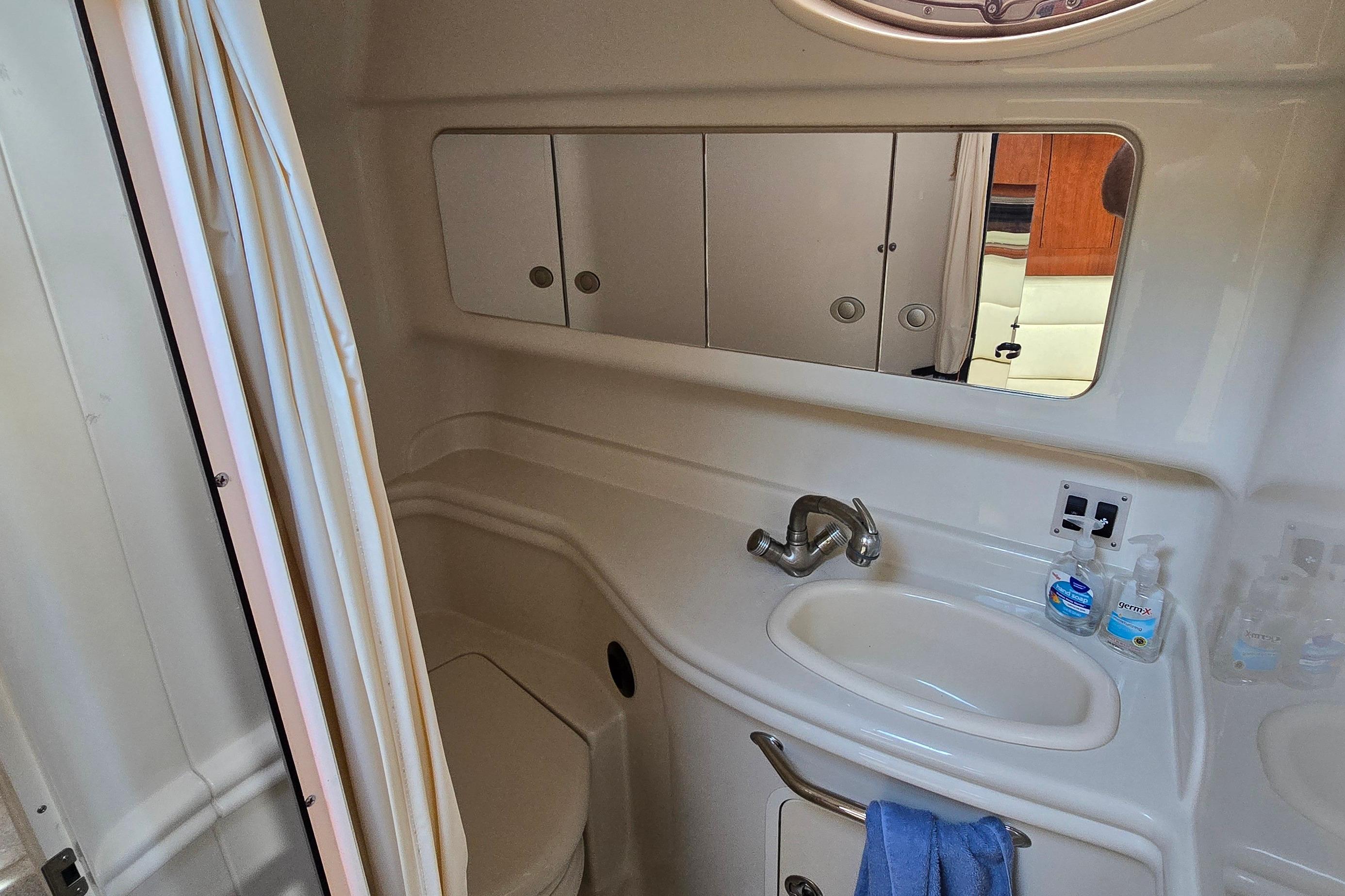 Bathroom interior of 2007 Sea Ray 340 Sundancer yacht with sink and mirror.
