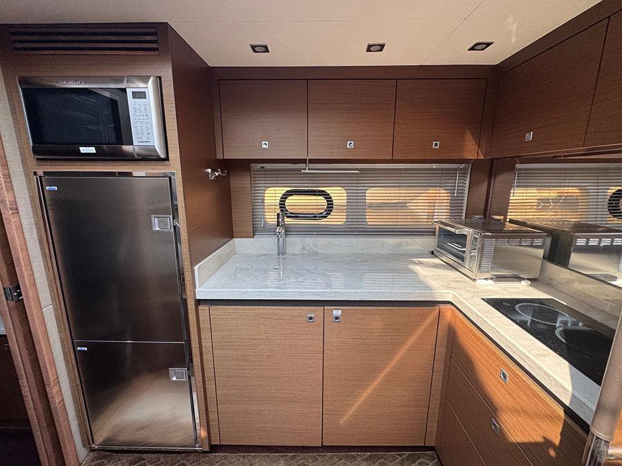 Luxurious kitchen interior of 2015 Sea Ray 510 Sundancer yacht with modern appliances.