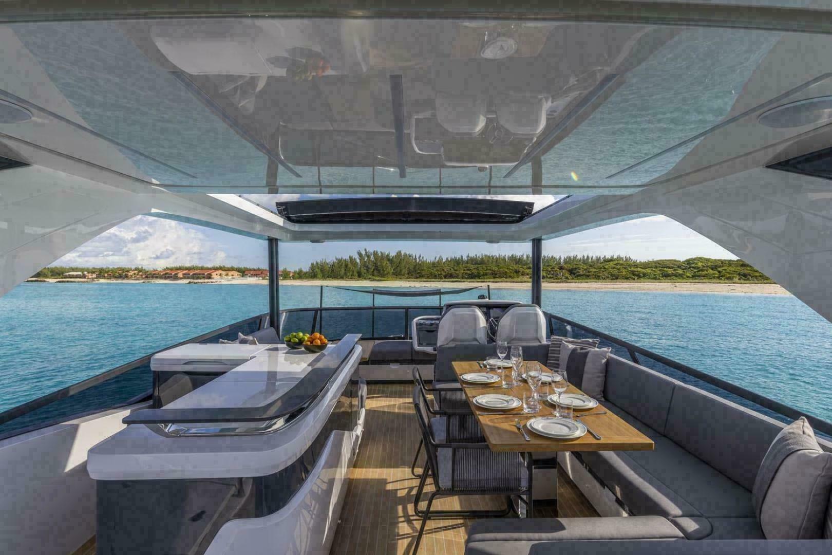 Luxurious 2023 Pearl 72 yacht interior with elegant dining setup and ocean view.