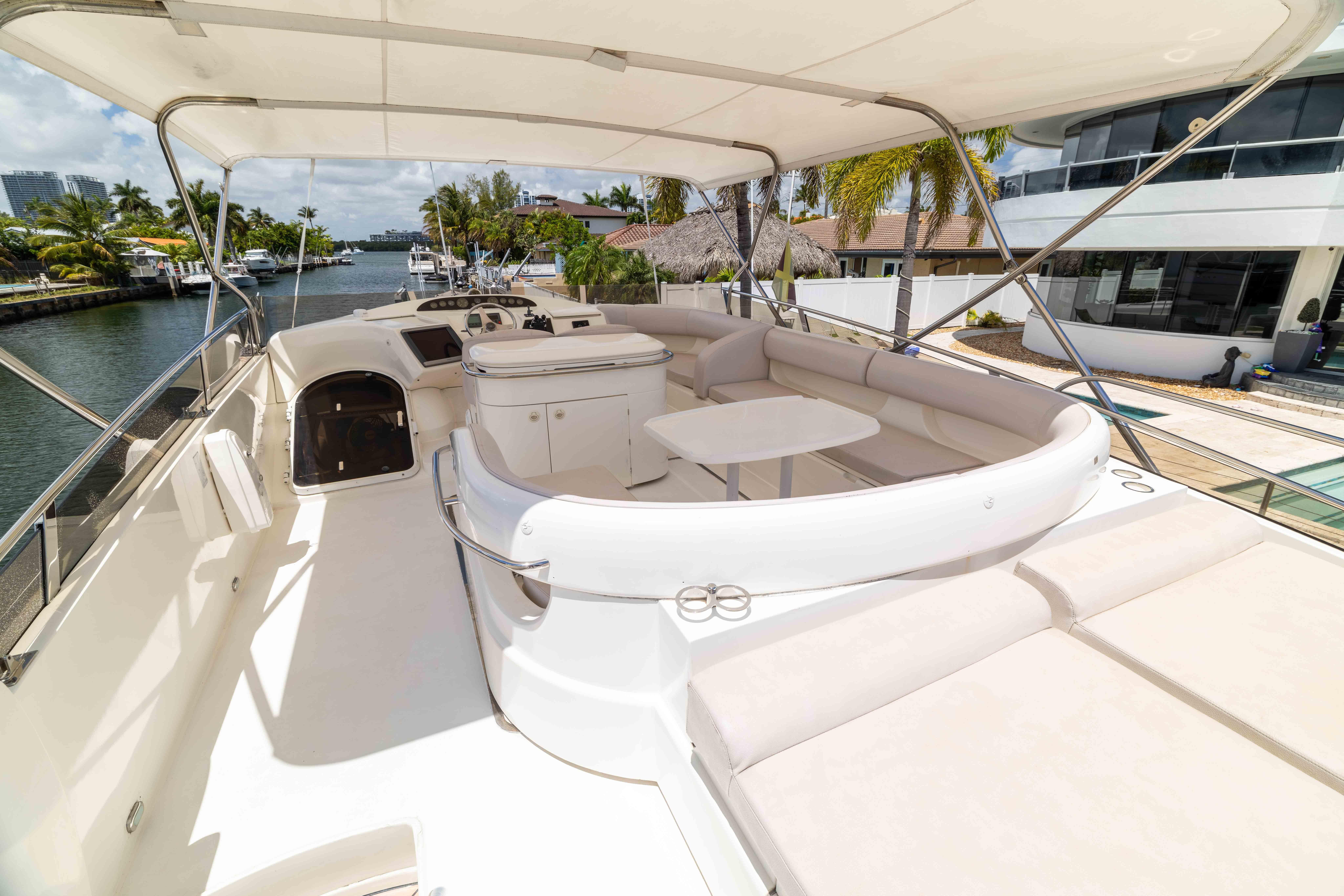 Luxurious 2002 Princess 61 yacht with spacious deck and elegant seating area.
