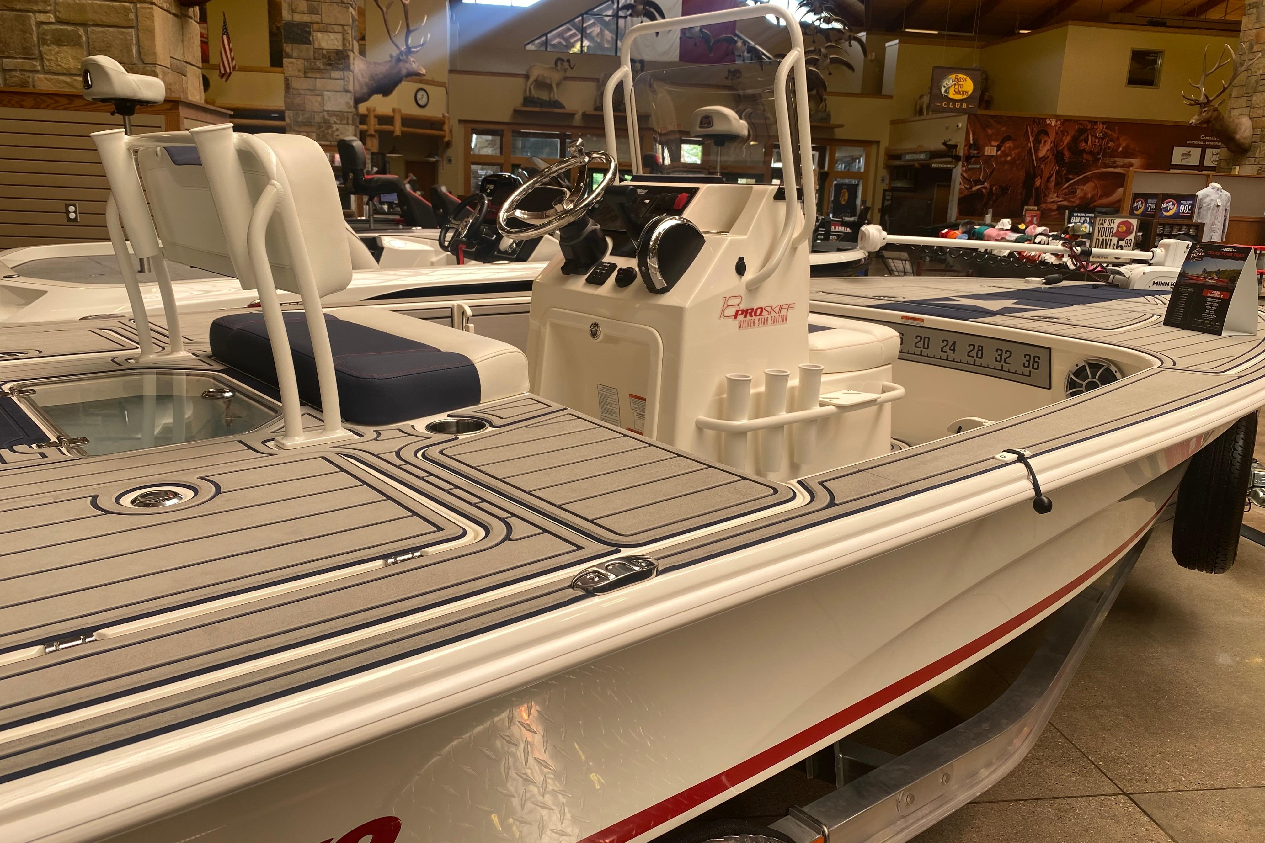 2025 Mako 18 Pro Skiff Patriot Edition boat displayed in a showroom.