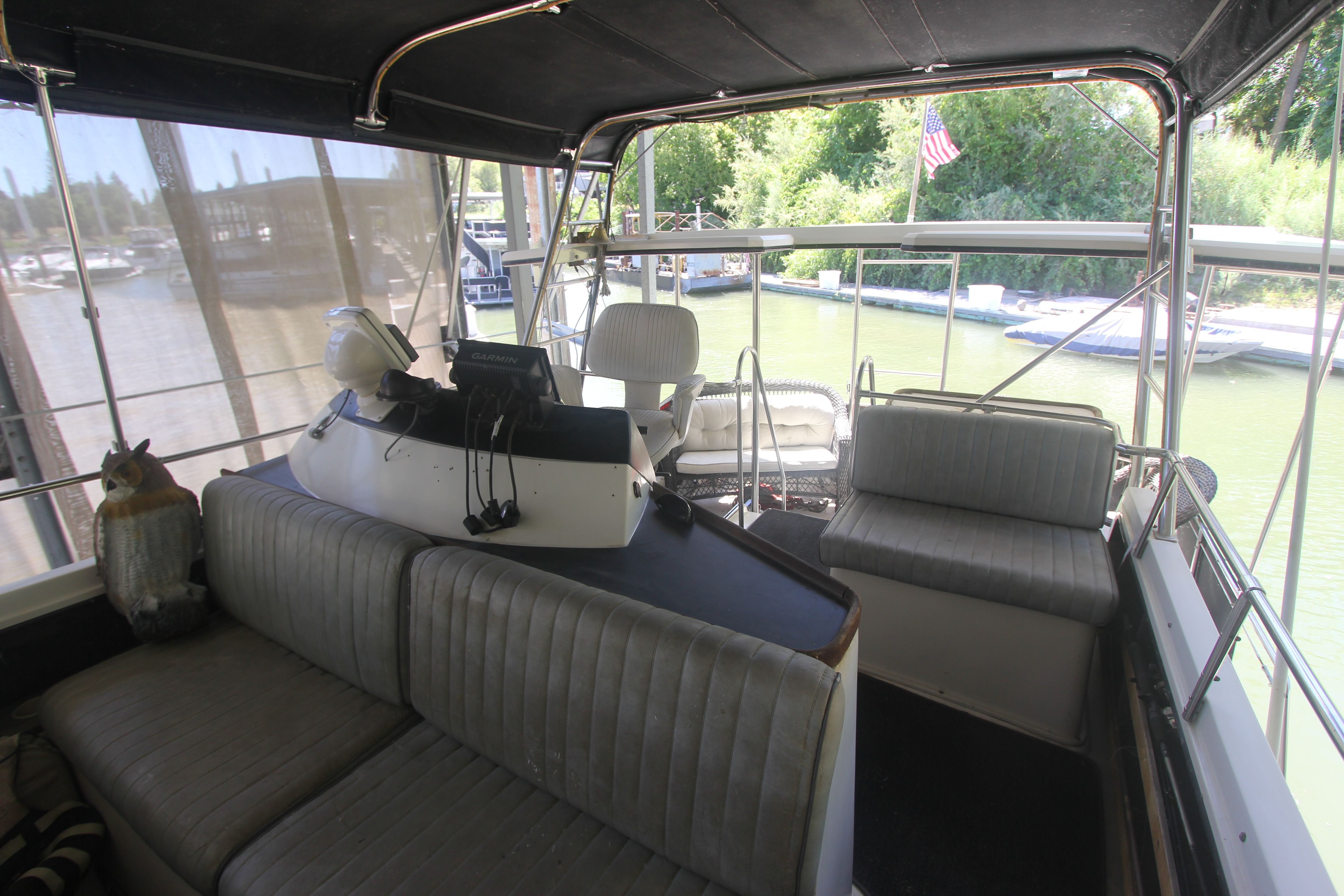 Interior of a 1988 Carver 3607 Aft Cabin Motor Yacht with seating area and helm.