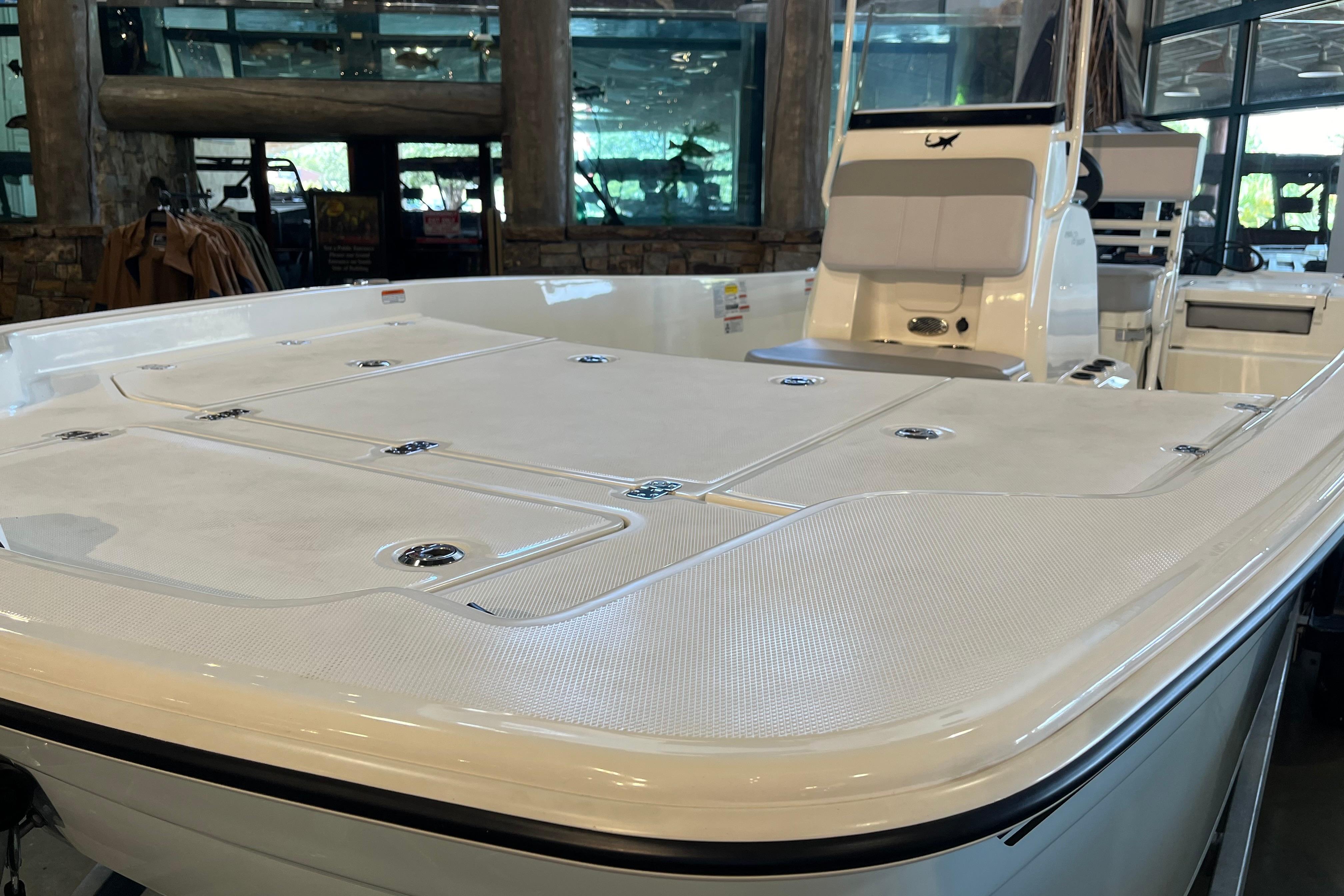 2024 Mako Pro Skiff 19 CC boat interior with seating and storage compartments.