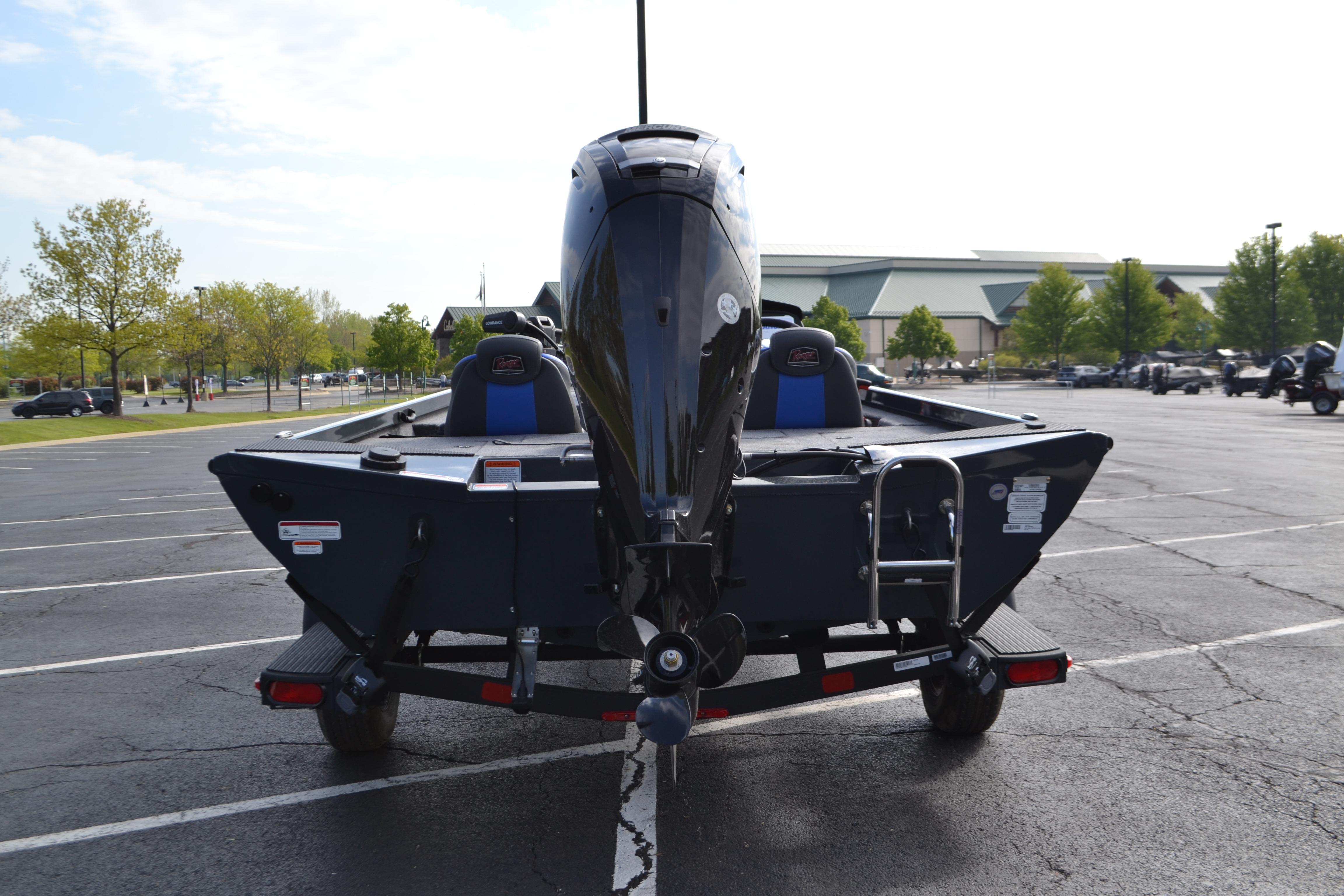 2026 Ranger RT178 boat in parking lot, rear view with motor and ladder.