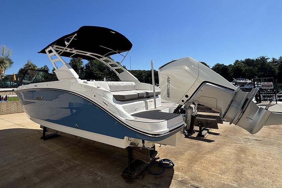 2027 Sea Ray SDX 230 Outboard boat with Mercury engine, parked outdoors under clear sky.