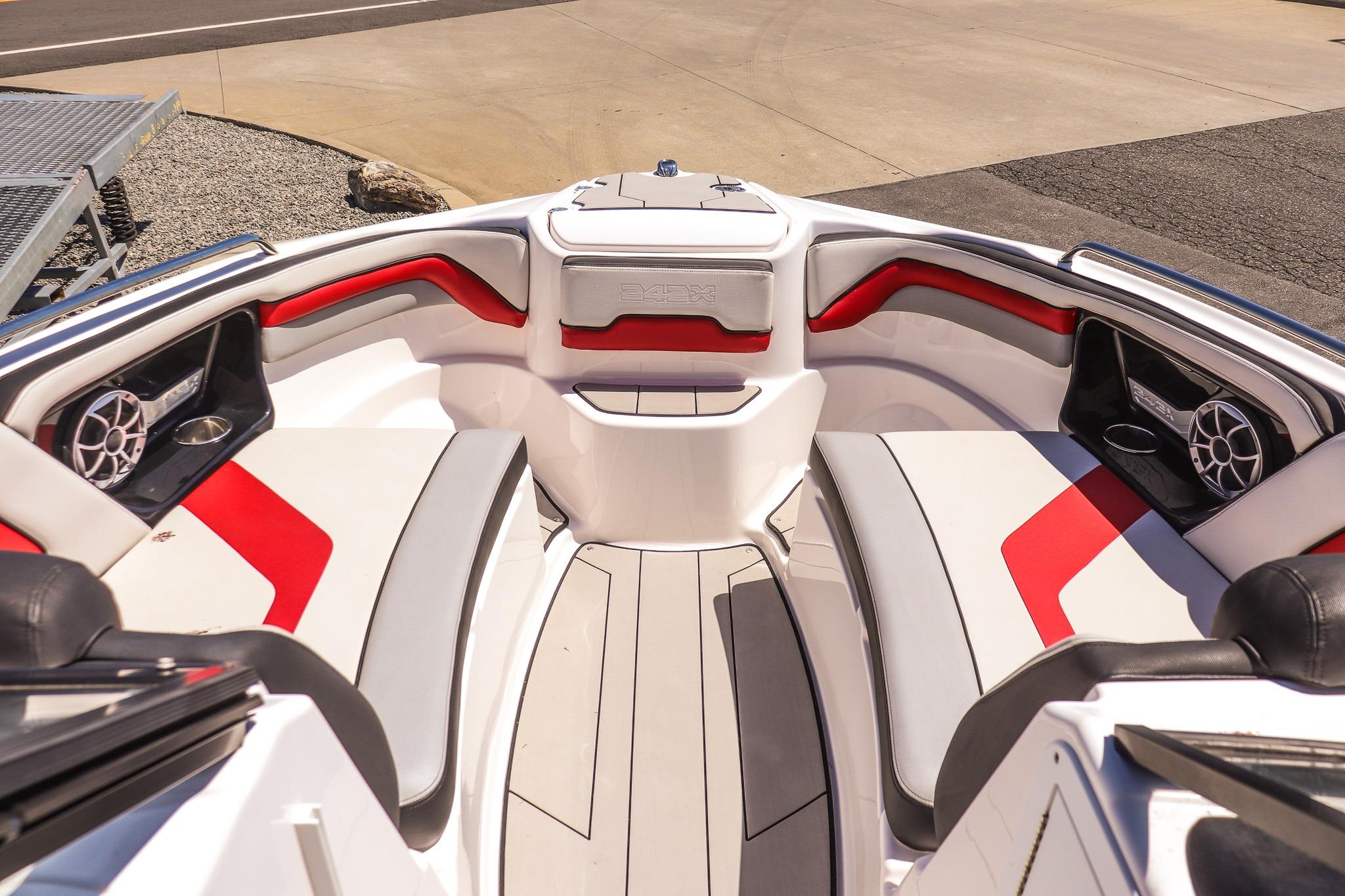 Interior of 2020 Yamaha Boats 242X, featuring red and white seating with speakers.