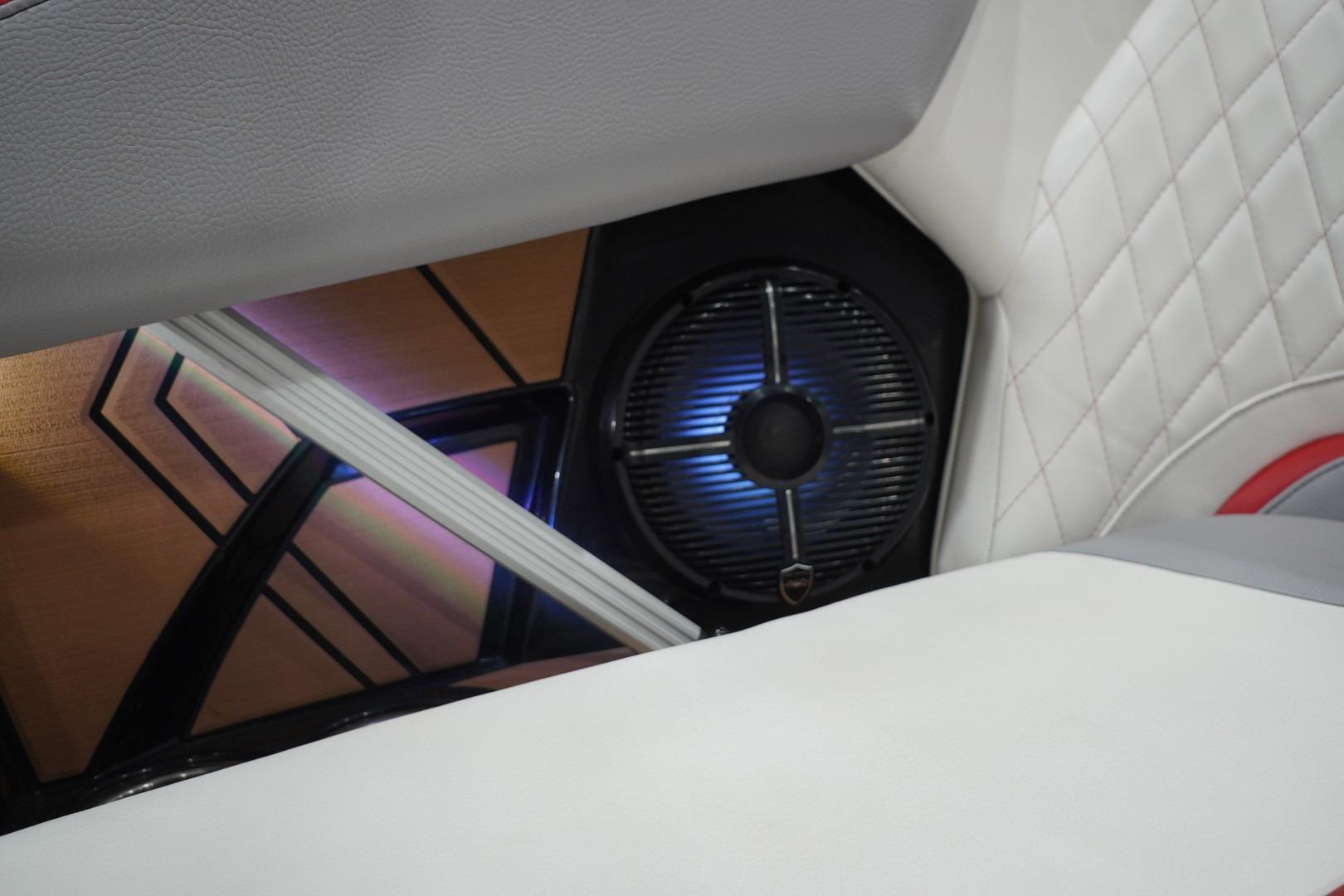 Interior of 2022 Tigé 22RZX boat featuring illuminated speaker and quilted upholstery.